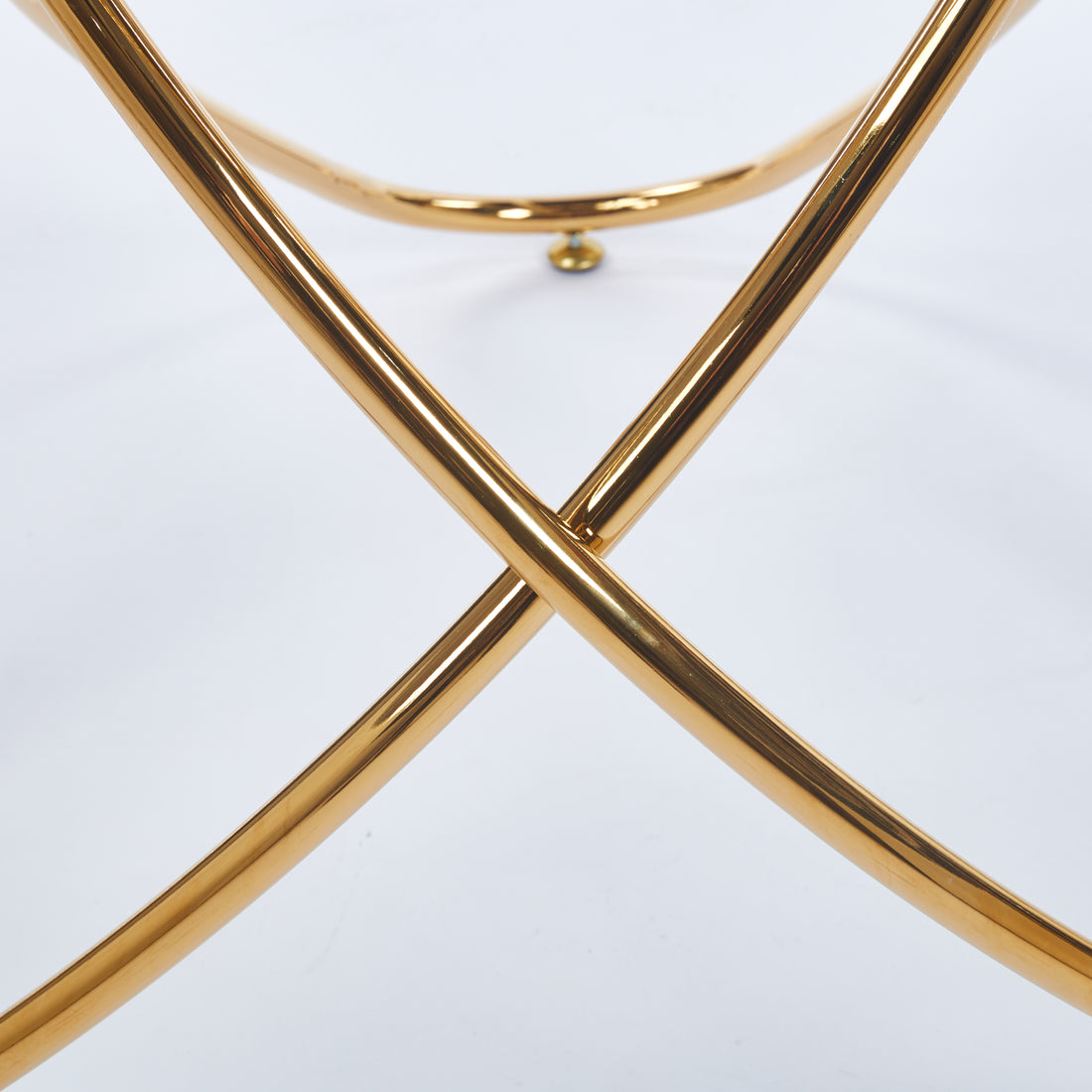 Adriatic gold dining table showing gold metal x-base detail