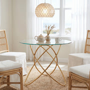 Adriatic gold dining table showing a round glass table in a bright dining space