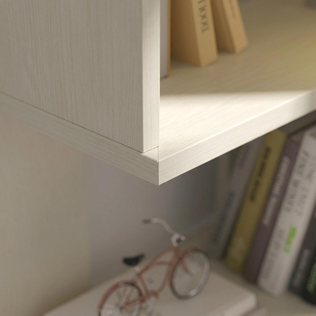 Agora white corner bookshelf showing rounded shelf edge and wood grain finish detail