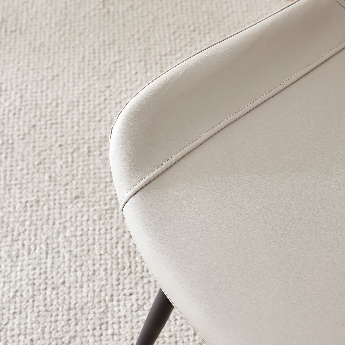 Amalfi light grey dining chair close-up of the curved faux leather seat edge and stitching