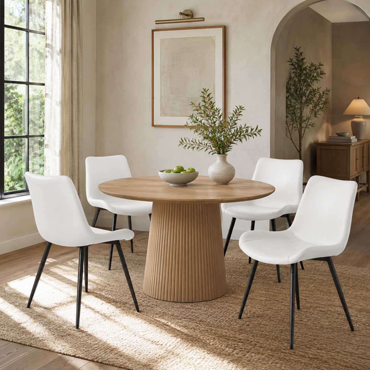 Amalfi white dining chairs in a bright dining room with a round wood table