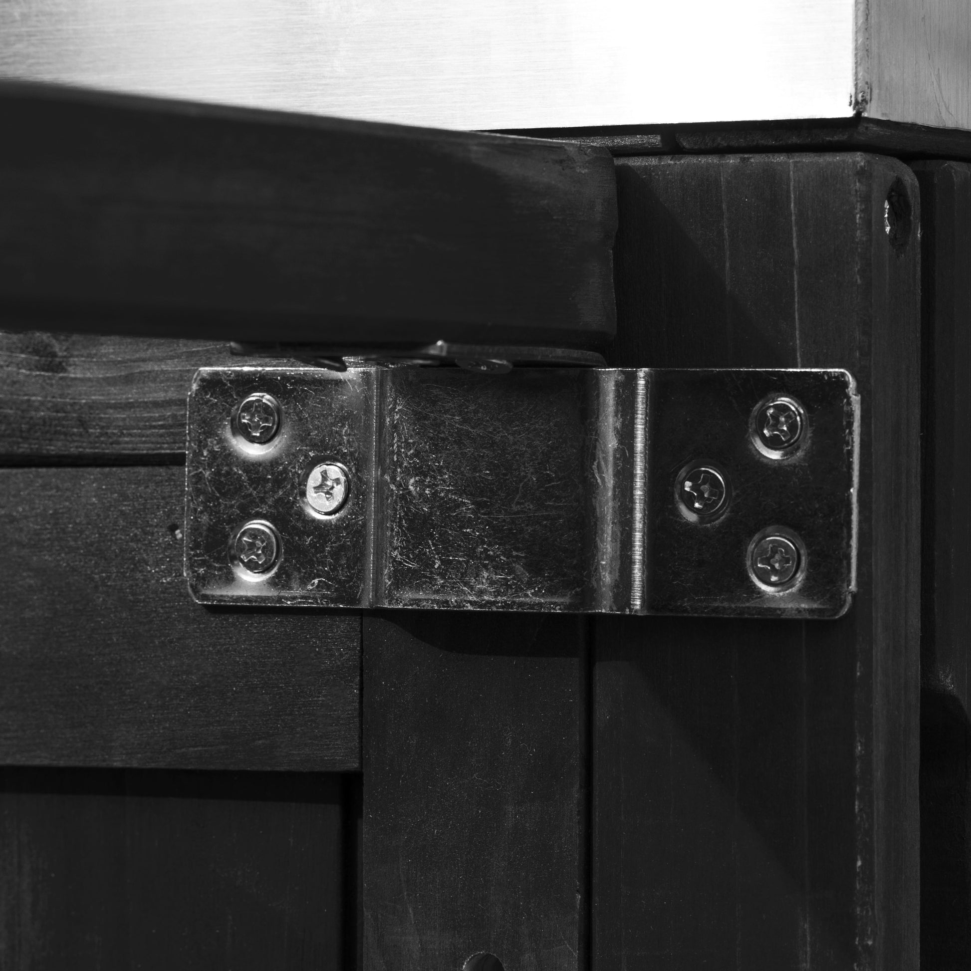 Antibes black outdoor kitchen island showing reinforced metal support bracket connecting frame components for enhanced outdoor stability and durability