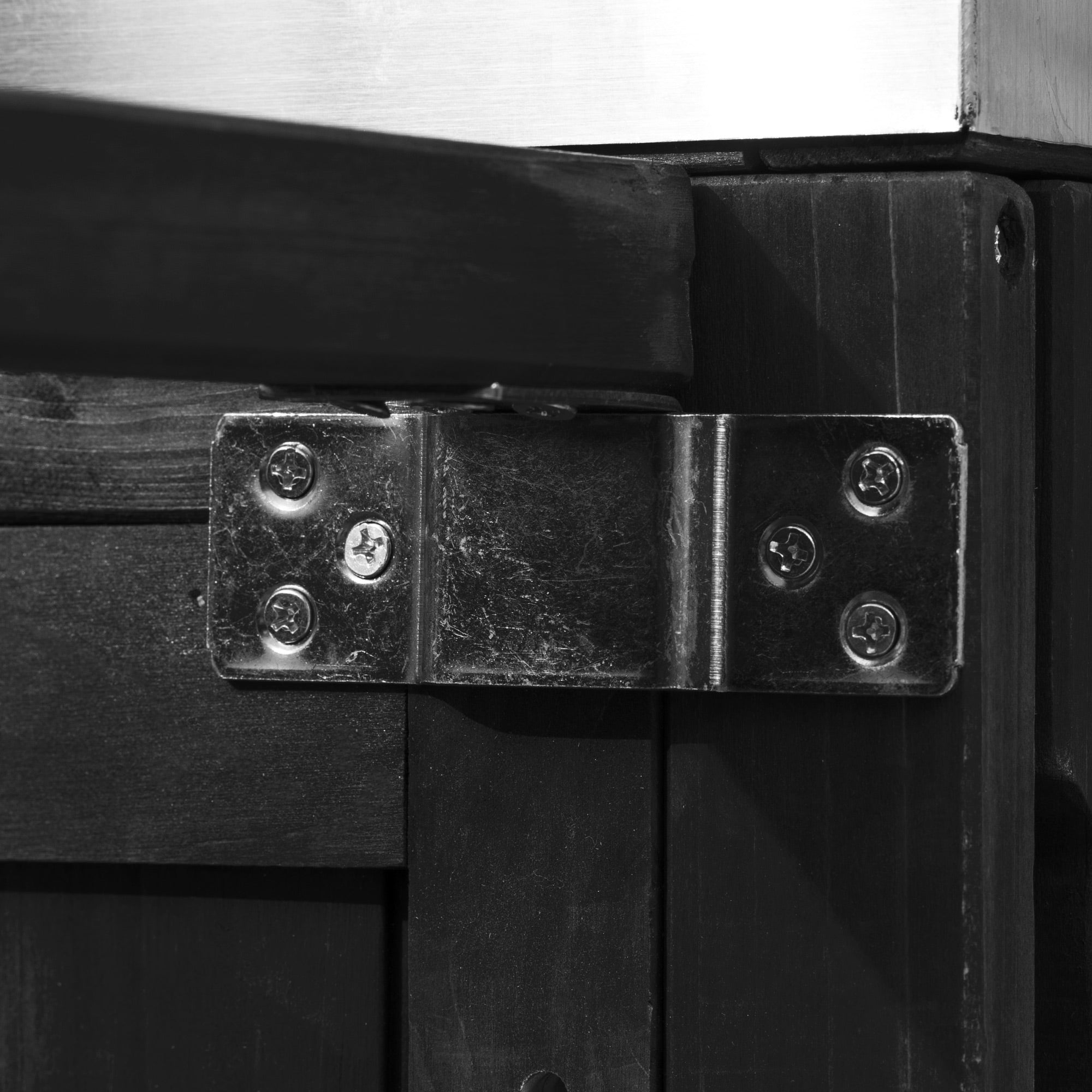 Antibes black outdoor kitchen island showing reinforced metal support bracket connecting frame components for enhanced outdoor stability and durability