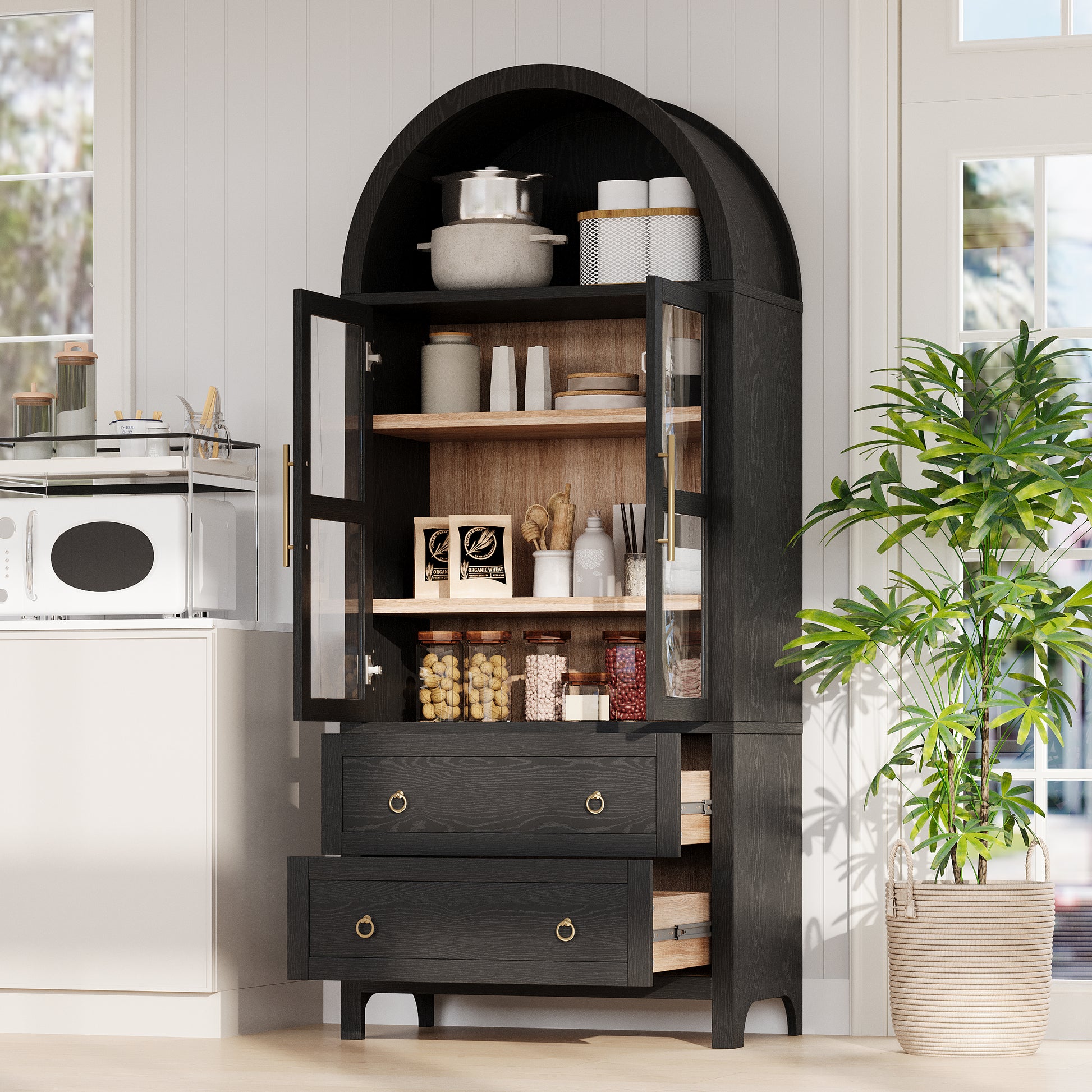 Black Artisan 71 - inch arched pantry cabinet with open glass doors and pull - out drawers displaying organized kitchen storage in a modern farmhouse kitchen scene