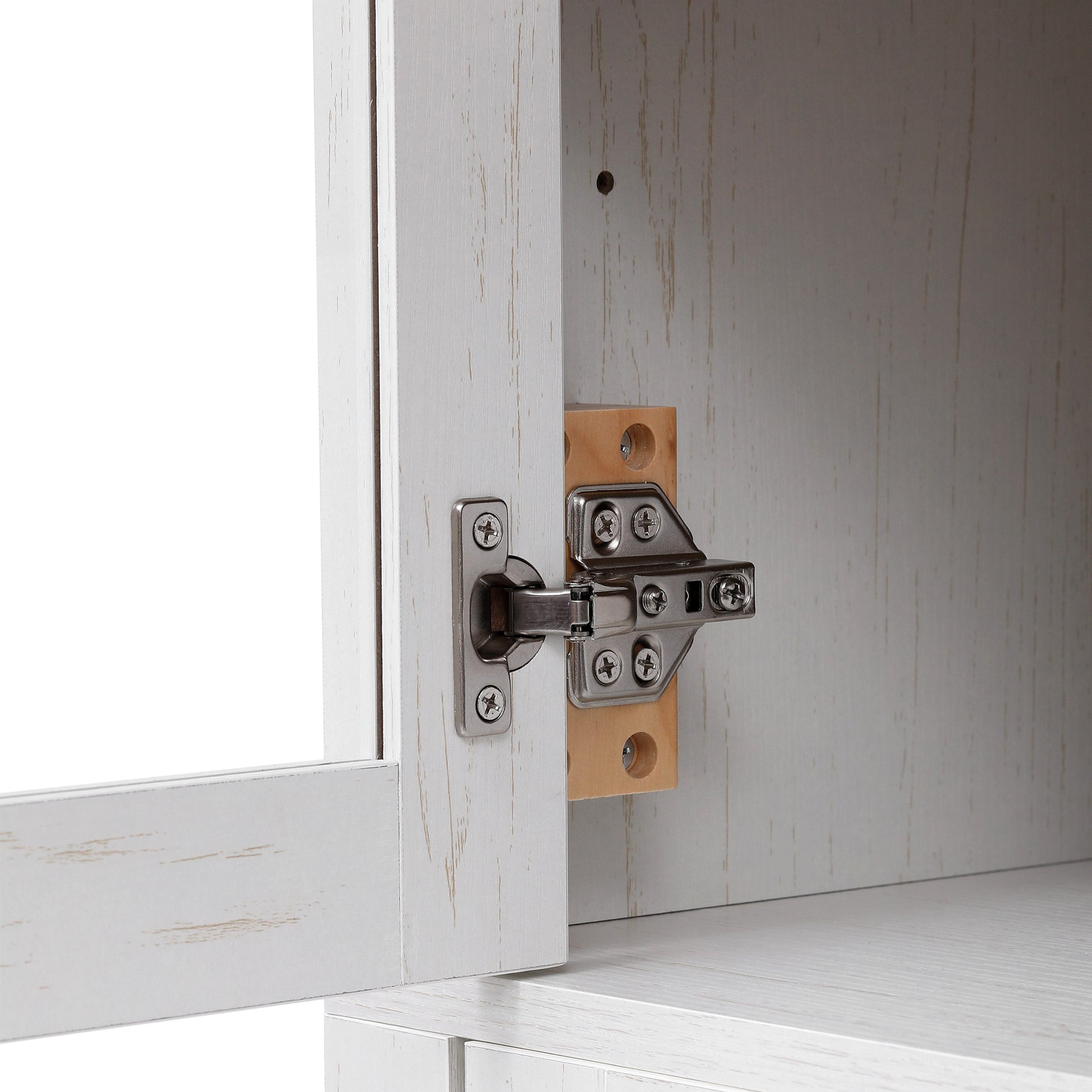 Close-up detail of the concealed metal hinge hardware on the Artisan white pantry cabinet showing durable construction and adjustable glass door support design