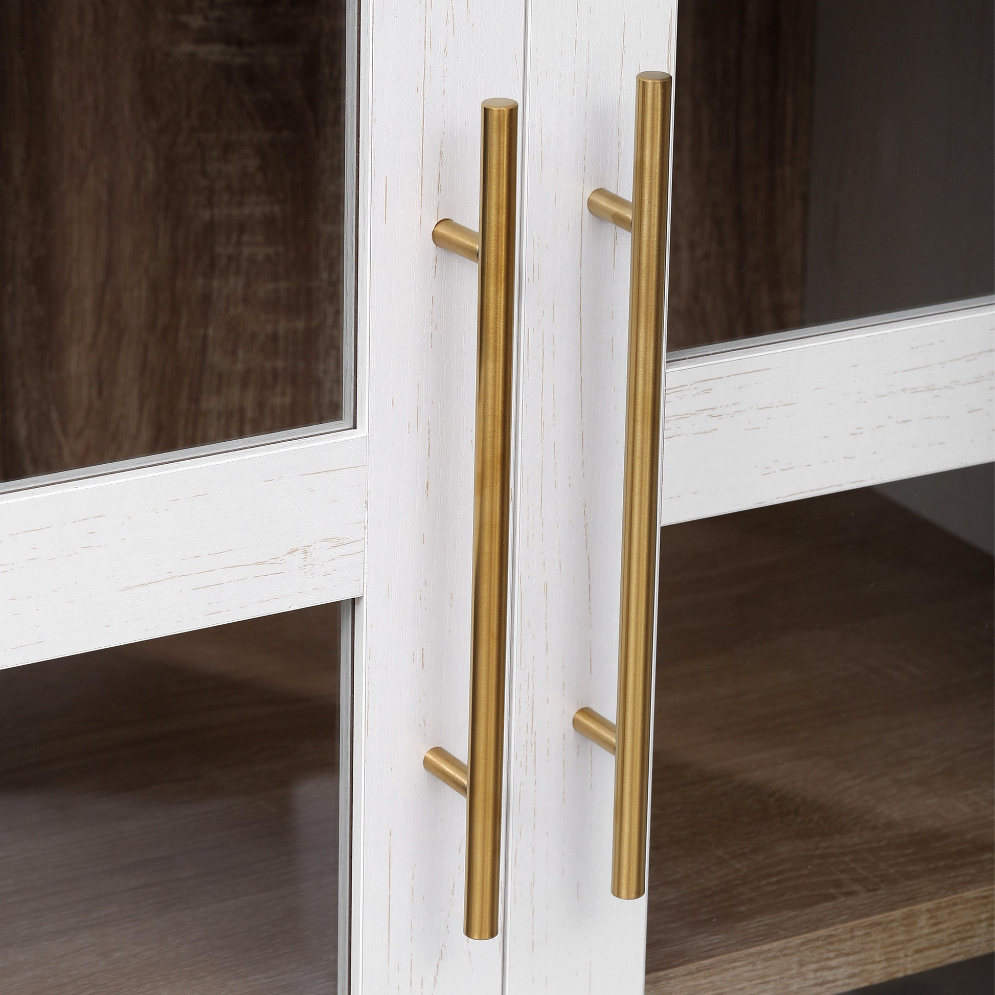 Close-up detail of the gold metal handles on the Artisan white glass door pantry cabinet showcasing modern farmhouse hardware and wood grain finish