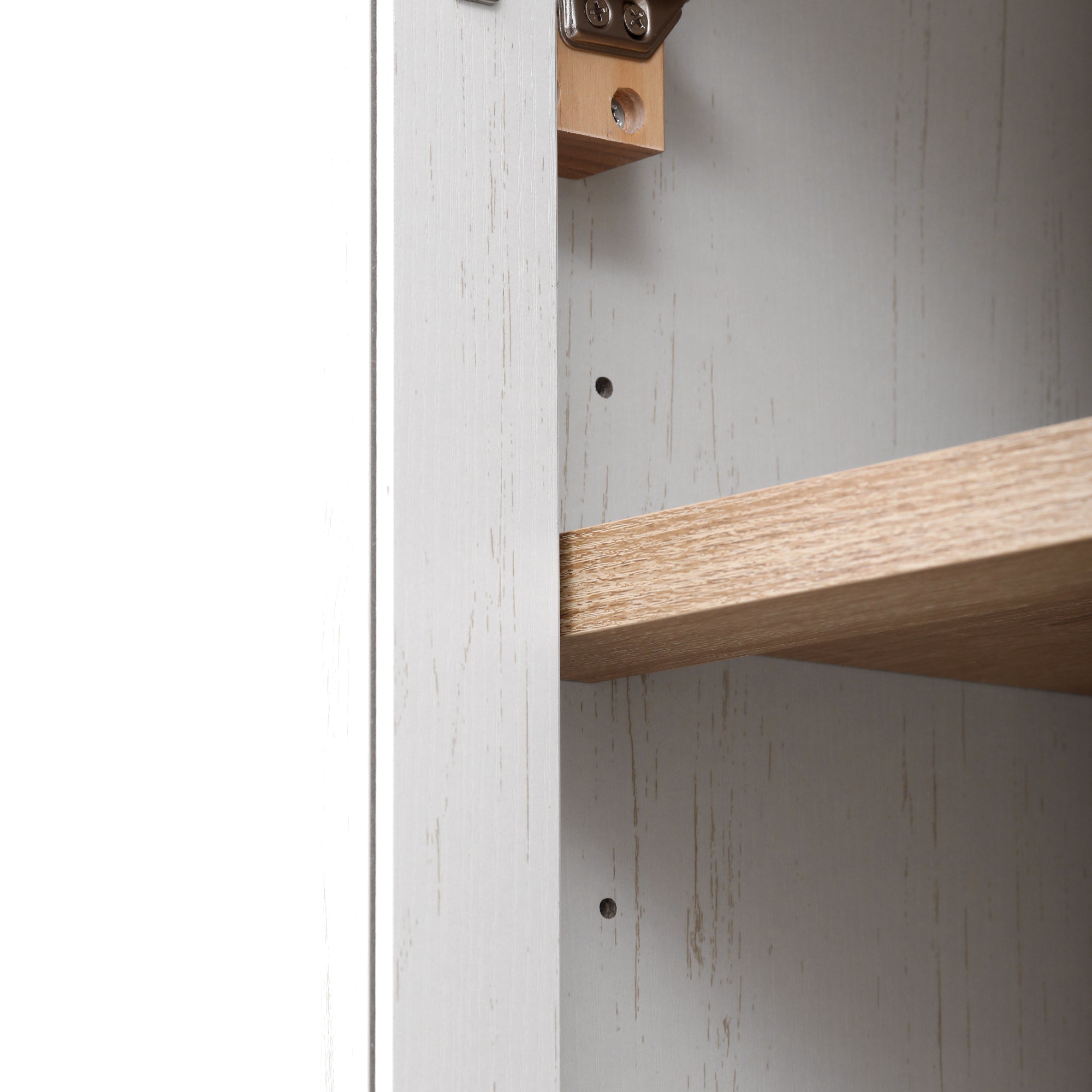 Close-up detail of the adjustable interior shelf system inside the white Artisan pantry cabinet with wood-tone shelving and farmhouse-style finish