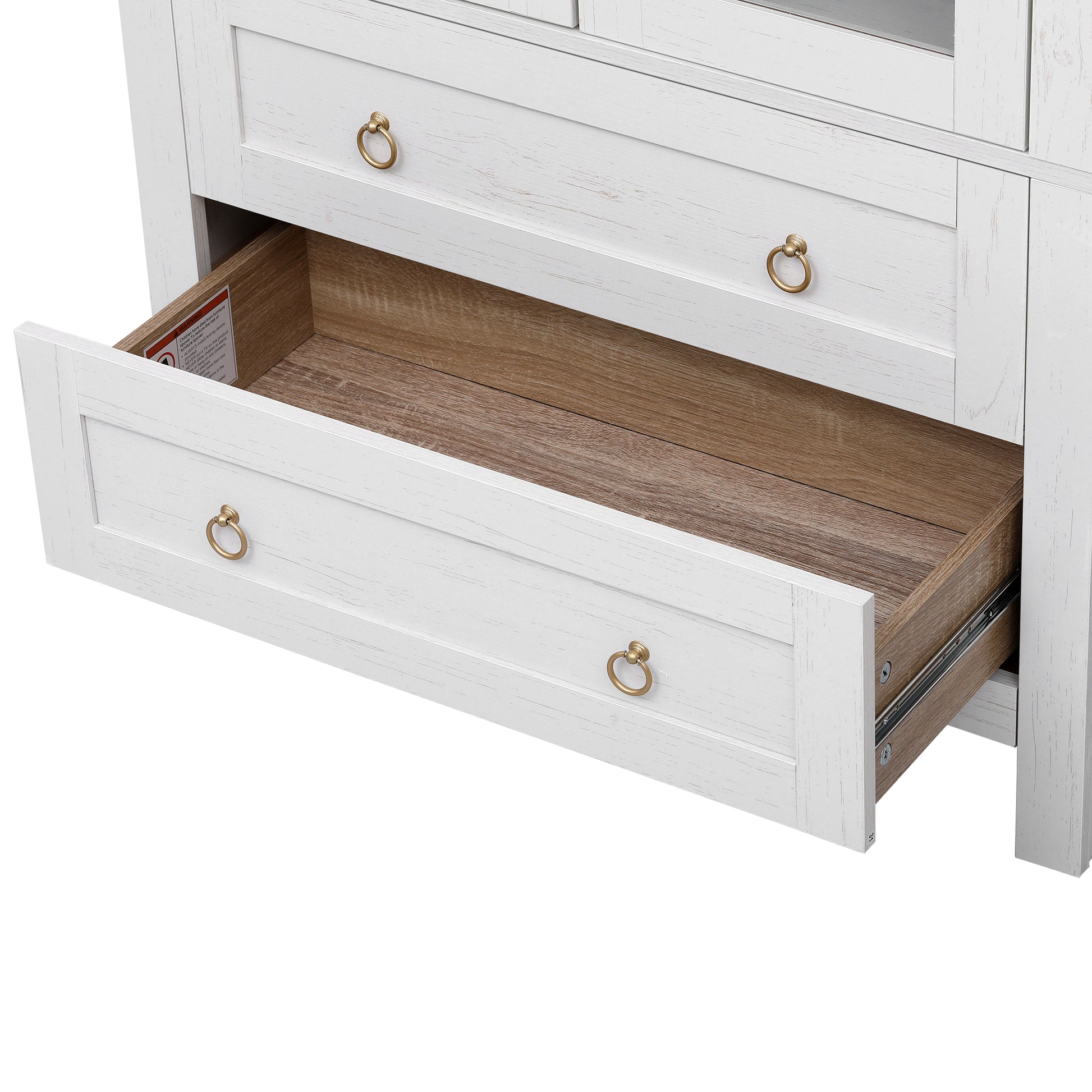 Close-up of the open lower storage drawer on the white Artisan pantry cabinet featuring spacious wood-tone interior and gold ring pull hardware