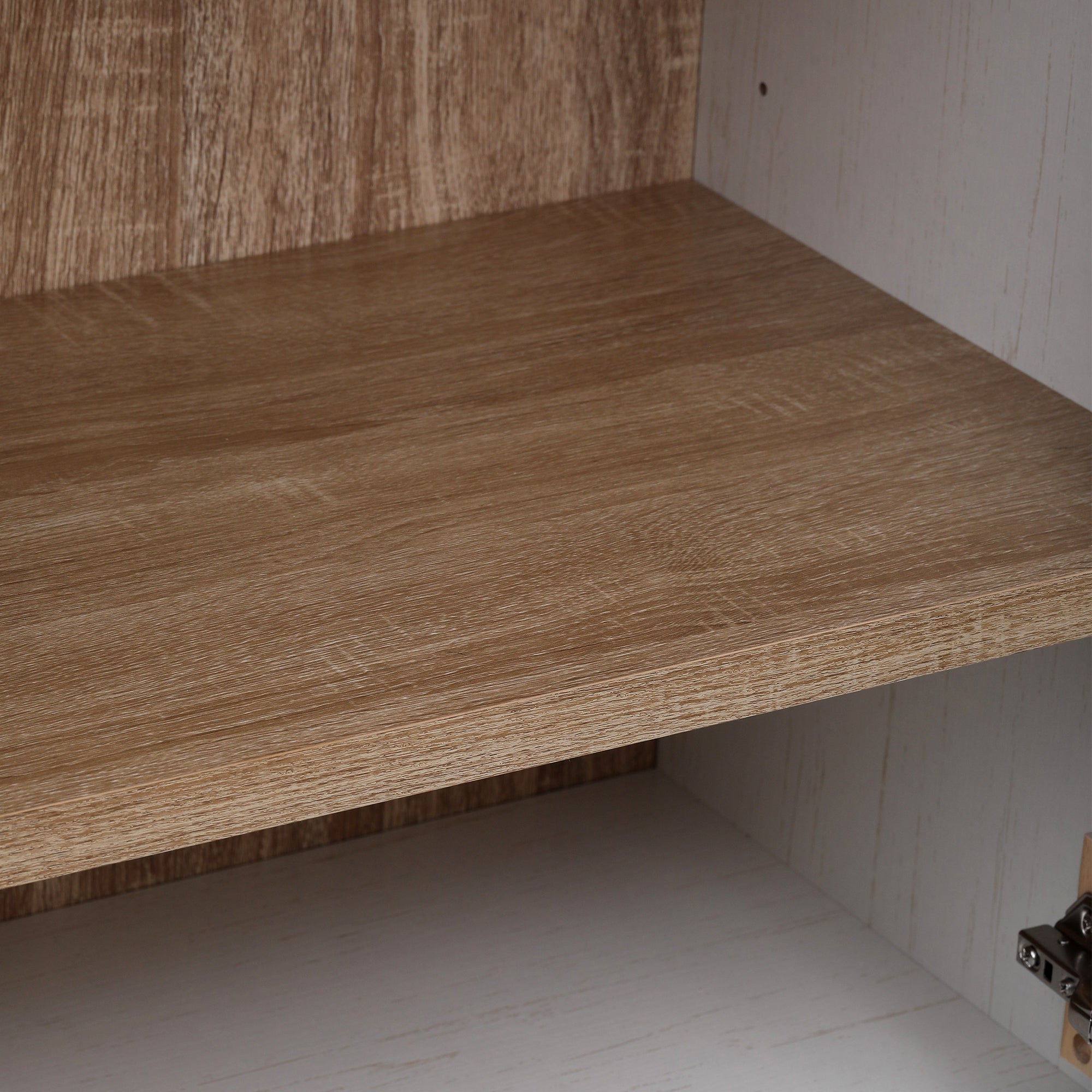 Close-up detail of the wood-grain interior shelf inside the white Artisan pantry cabinet showing farmhouse-style finish and storage surface texture