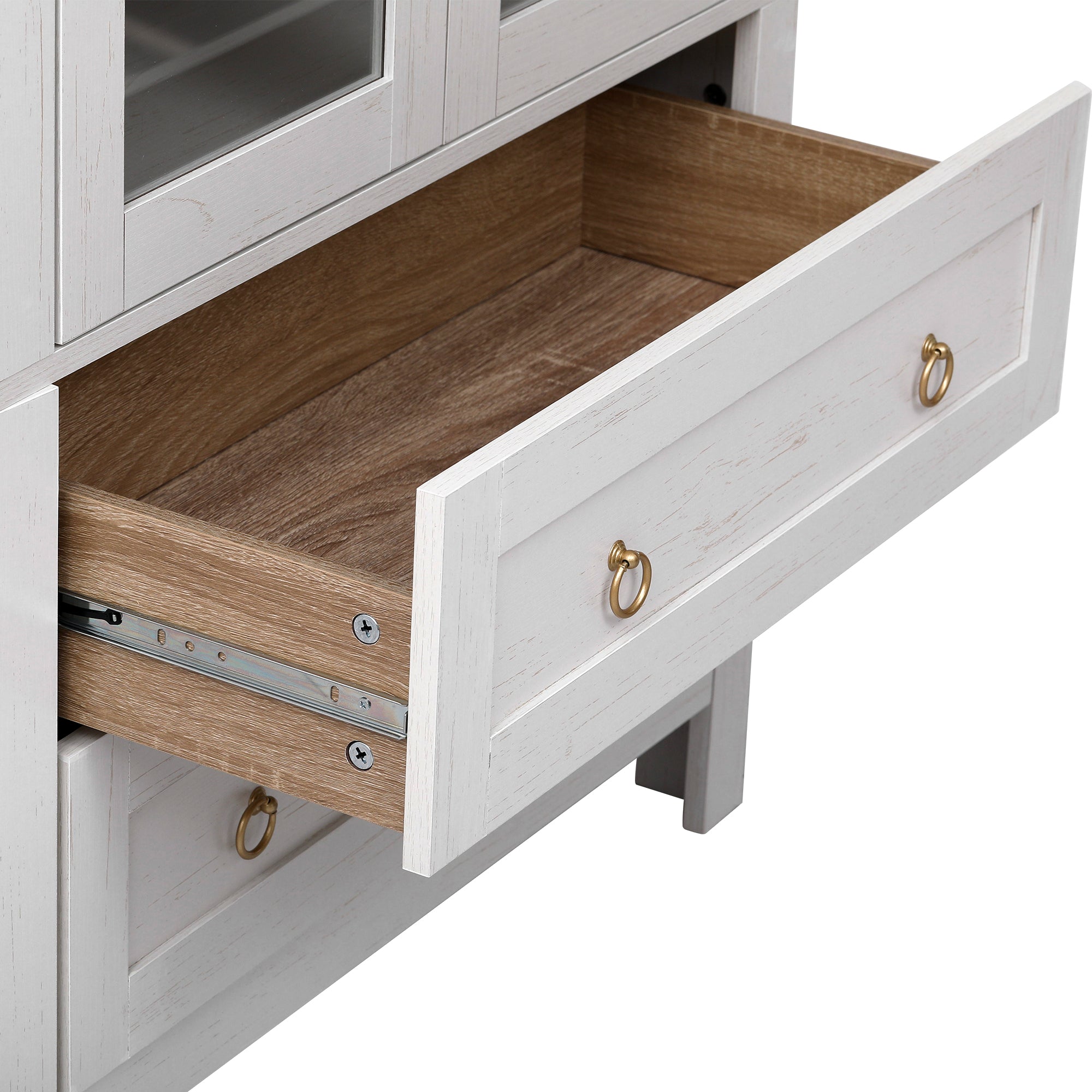 Close-up of the Artisan white pantry cabinet drawer featuring spacious storage capacity wood grain interior and gold ring pull hardware with smooth metal drawer slides