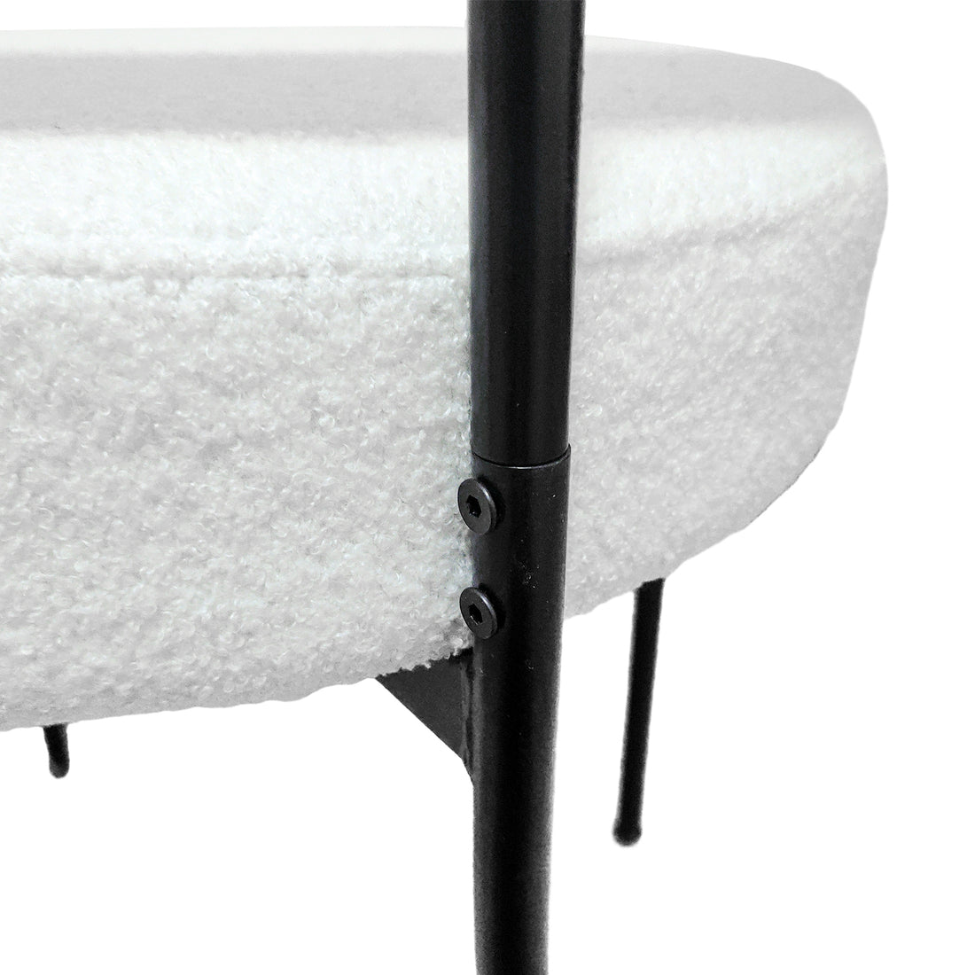 Bled white dining chair close-up of the back upholstery and black metal leg connection