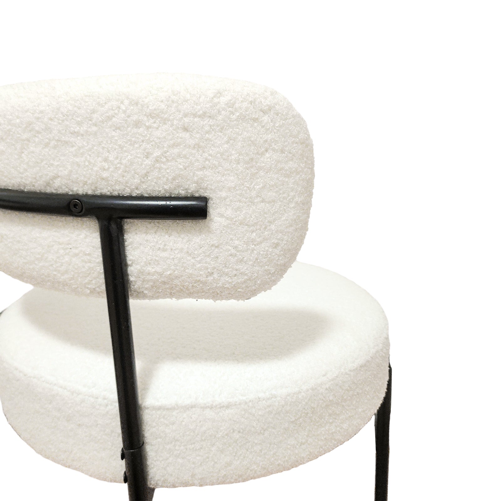 Bled white dining chair rear view showing the curved upholstered back and slim black legs