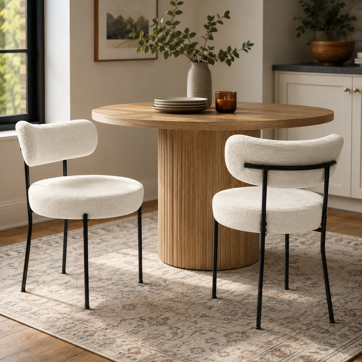 Bled white dining chairs in a bright dining room with a natural wood pedestal table