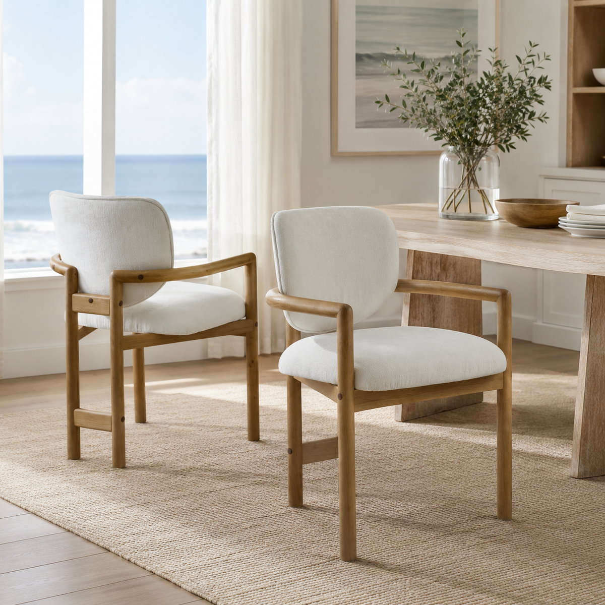 Bracciano oak dining armchairs around a round dining table in a sunlit dining space
