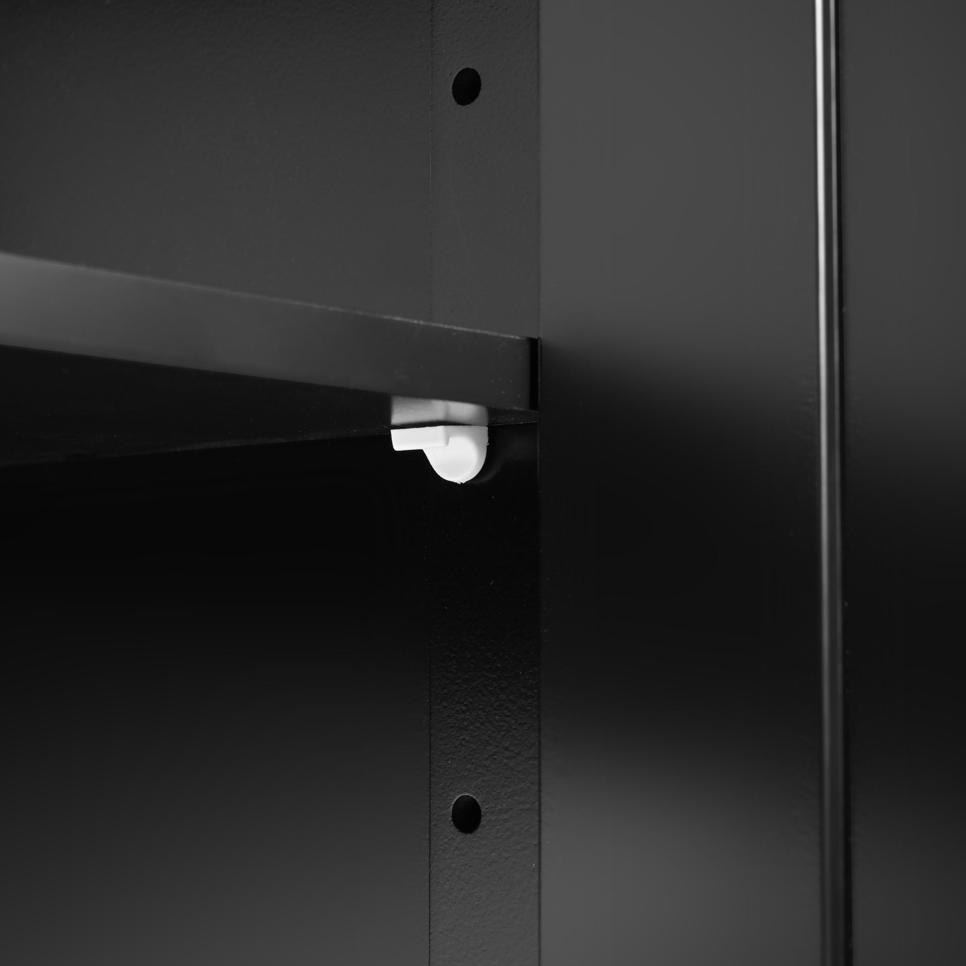 Close-up detail of the BRYNNA black kitchen island featuring adjustable interior shelving with customizable shelf height support system for flexible kitchen storage