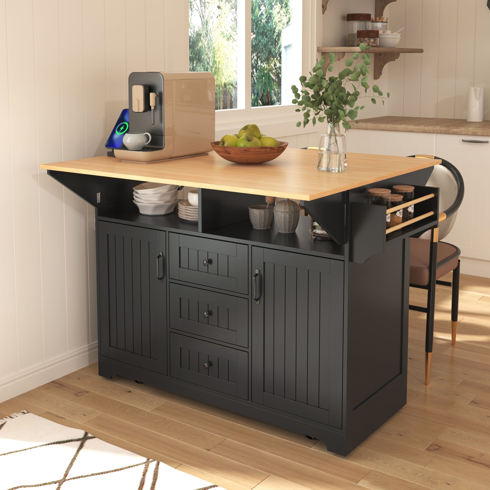 Lifestyle dining setup of the black BRYNNA rolling kitchen island with expanded drop leaf tabletop, open shelving, spice rack, and multifunctional farmhouse storage design in a cozy kitchen space