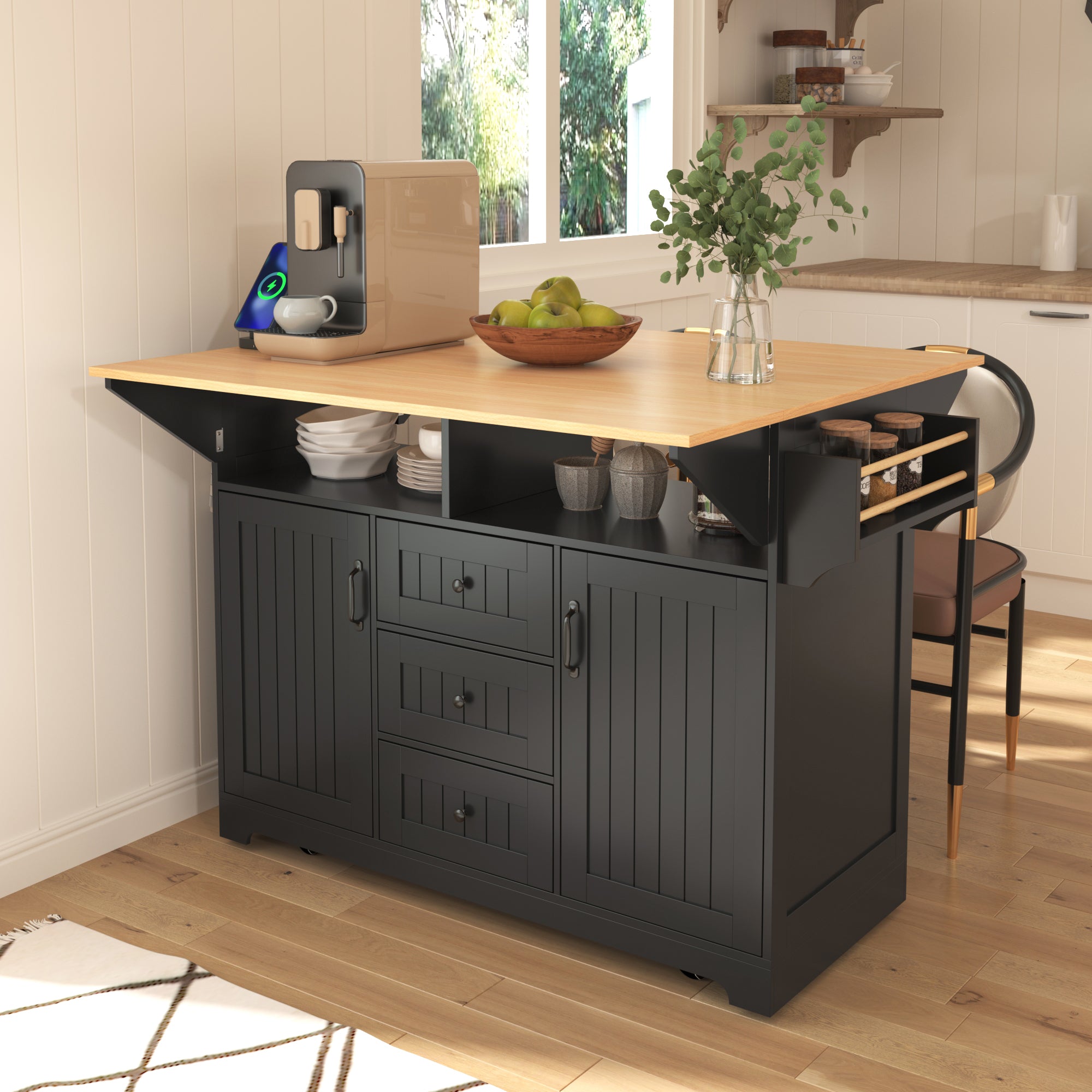 Lifestyle dining setup of the black BRYNNA rolling kitchen island with expanded drop leaf tabletop, open shelving, spice rack, and multifunctional farmhouse storage design in a cozy kitchen space