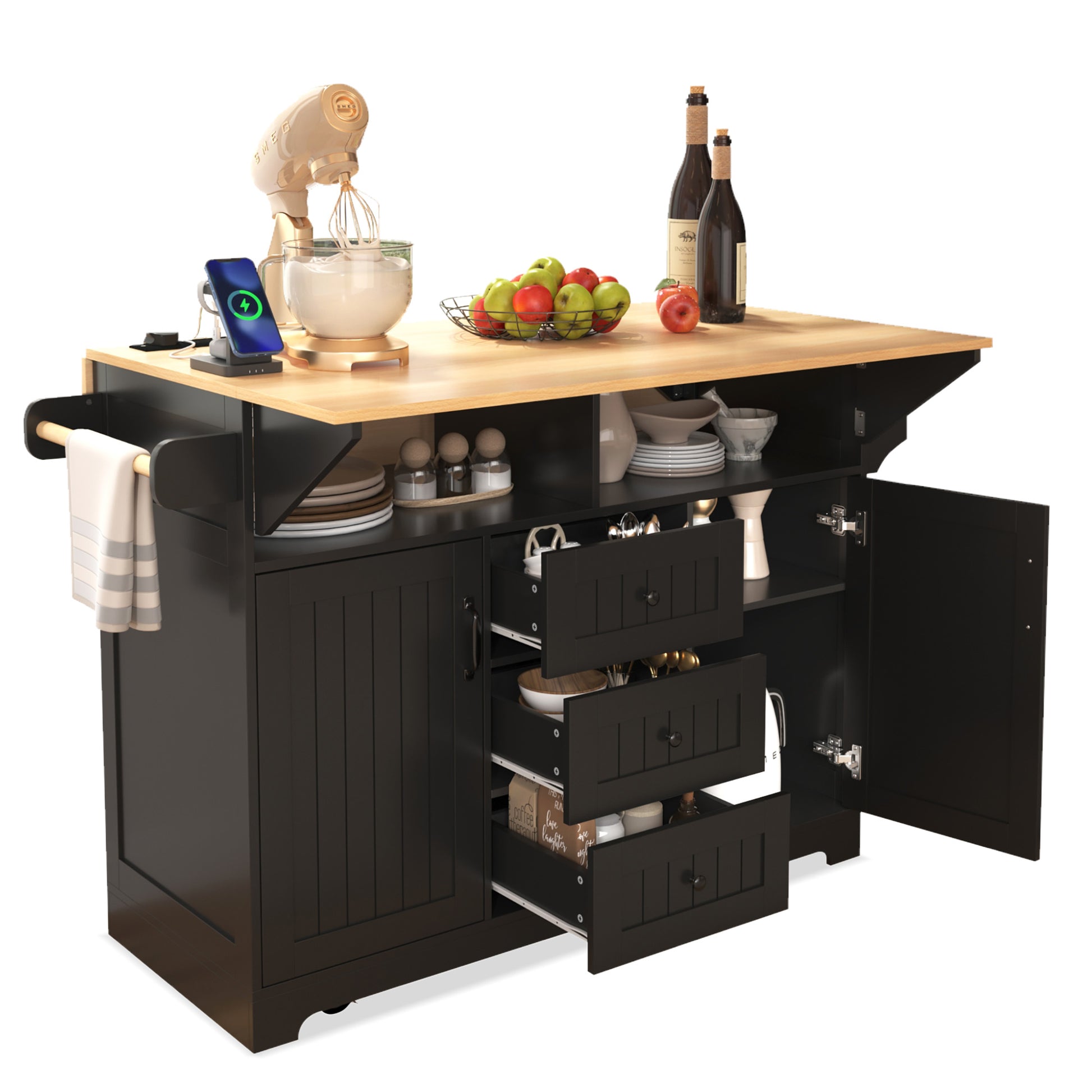 Lifestyle view of the black BRYNNA rolling kitchen island with open cabinet doors, pull out drawers, towel bar, expanded drop leaf countertop, and built in charging station for multifunctional kitchen storage