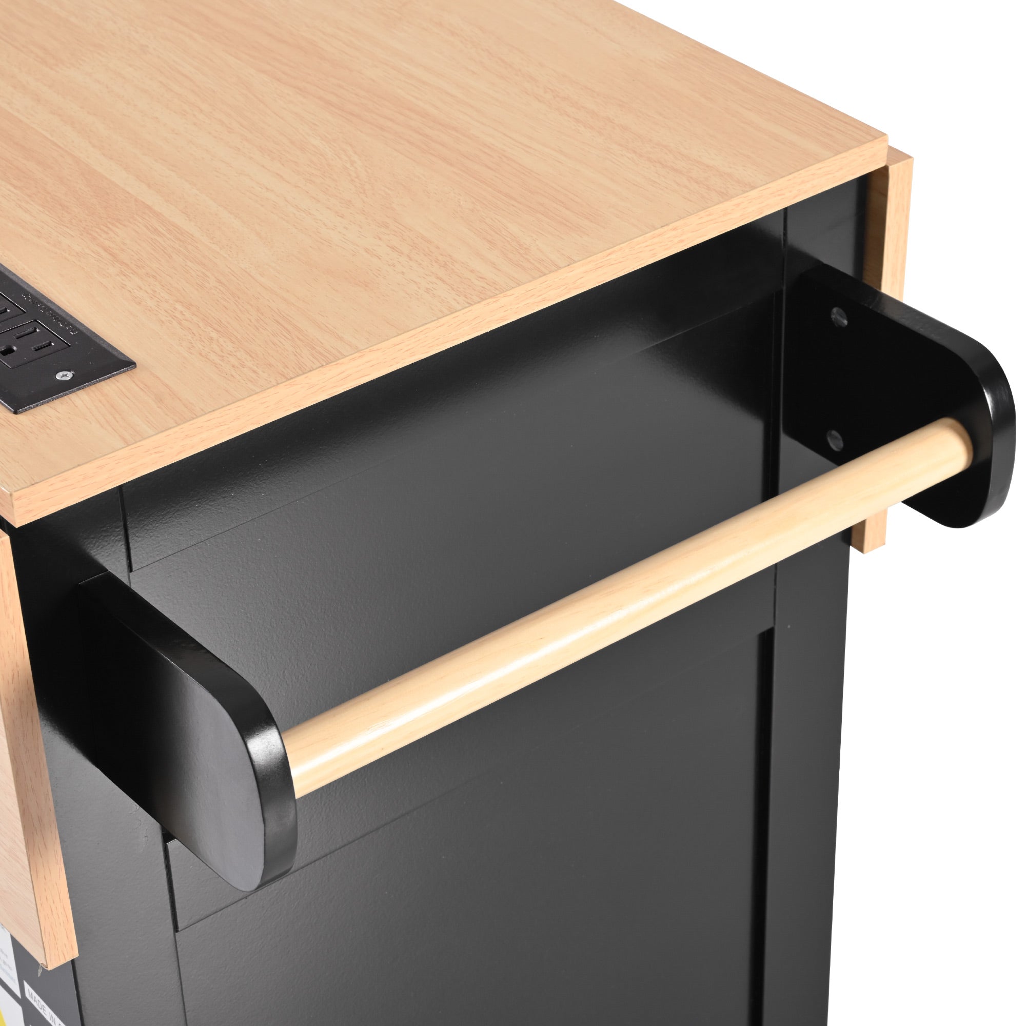 Close-up detail of the BRYNNA black rolling kitchen island featuring integrated wooden towel bar and natural wood countertop with built-in power outlet design