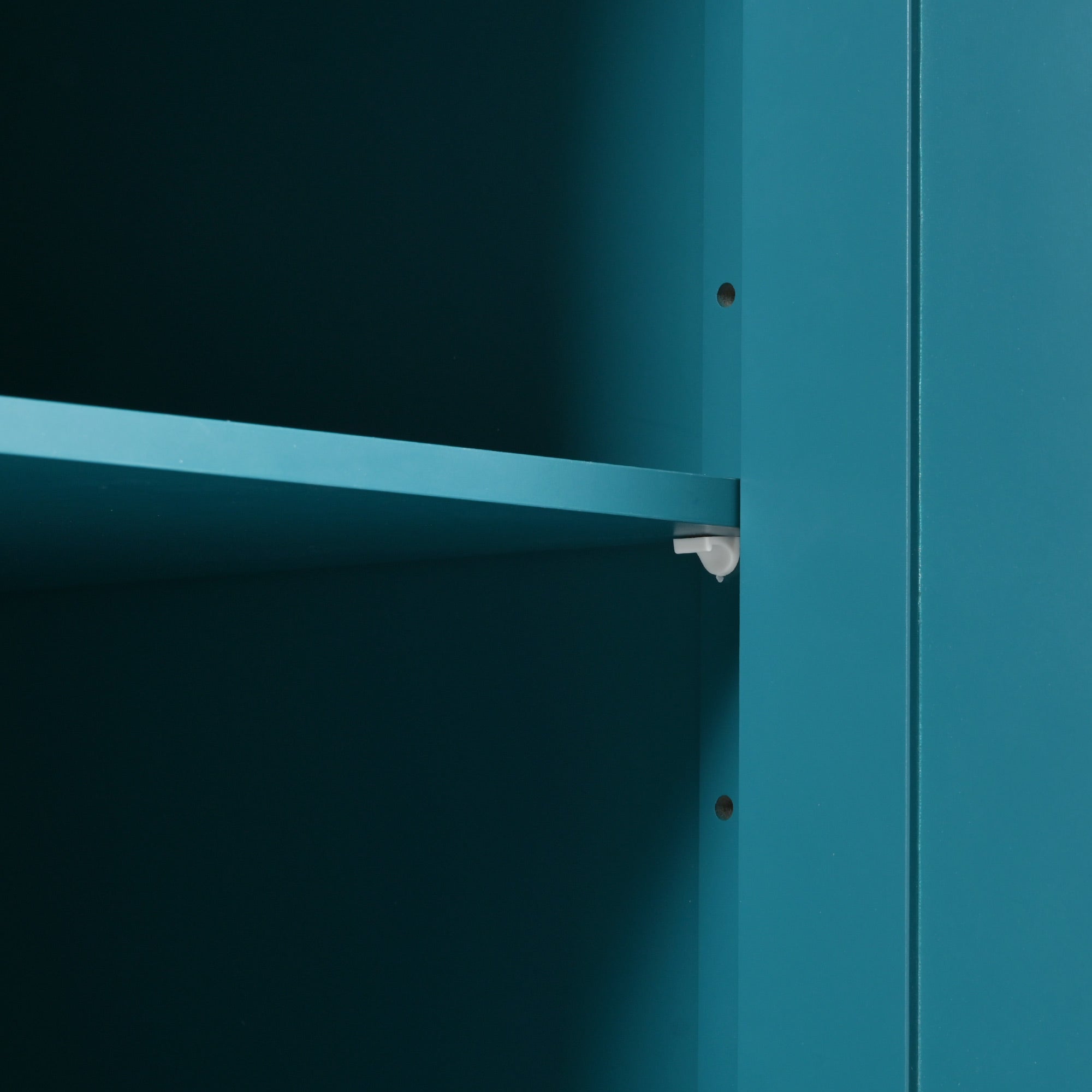 Close-up detail of the green BRYNNA kitchen island featuring adjustable interior shelf support system for customizable kitchen storage organization