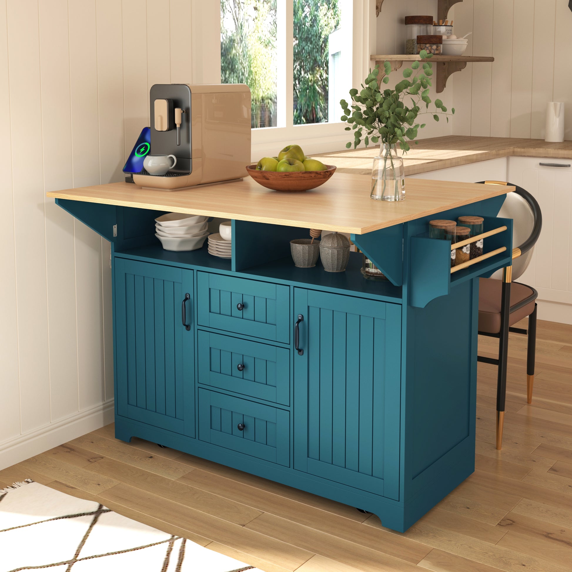 Lifestyle image of the green BRYNNA rolling kitchen island with drop leaf countertop, cabinet and drawer storage, spice rack, and farmhouse-inspired multifunctional kitchen design
