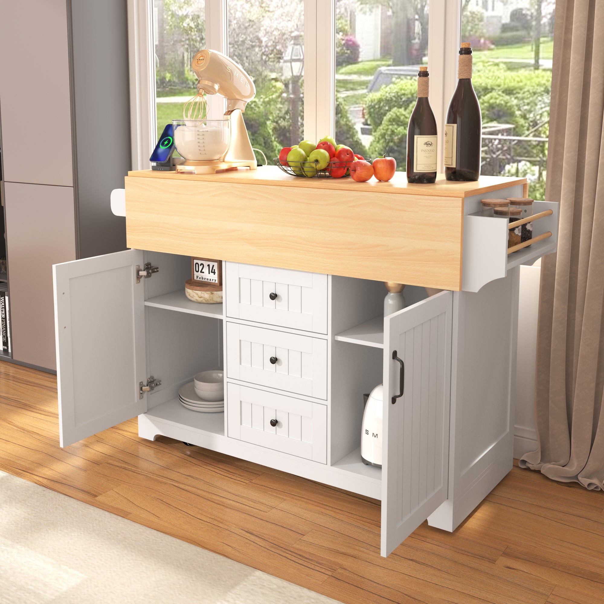 Lifestyle image of the white BRYNNA rolling kitchen island with extended drop leaf tabletop, open cabinet doors, drawer storage, spice rack, and multifunctional farmhouse kitchen design