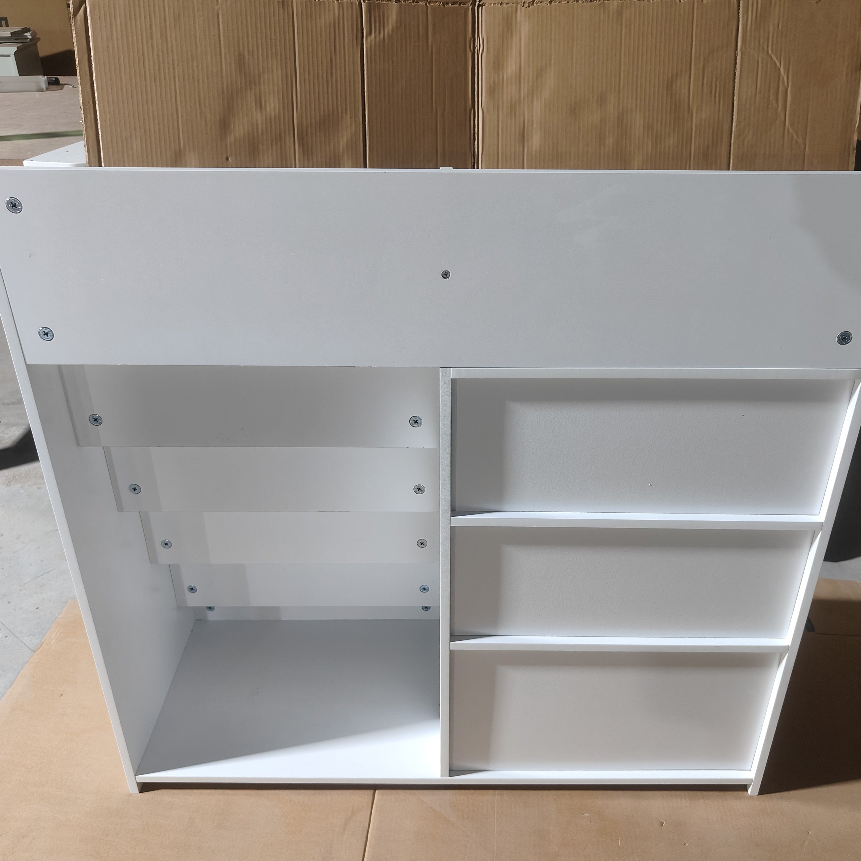 Bunny white bookshelf showing shelf dividers and lower storage compartments detail