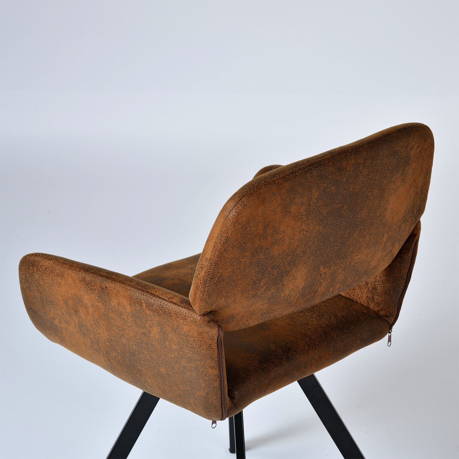 California suede brown swivel dining chair showing curved back and seat detail