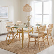 Caspian gold dining table showing a rectangular glass table with six chairs in a bright dining room