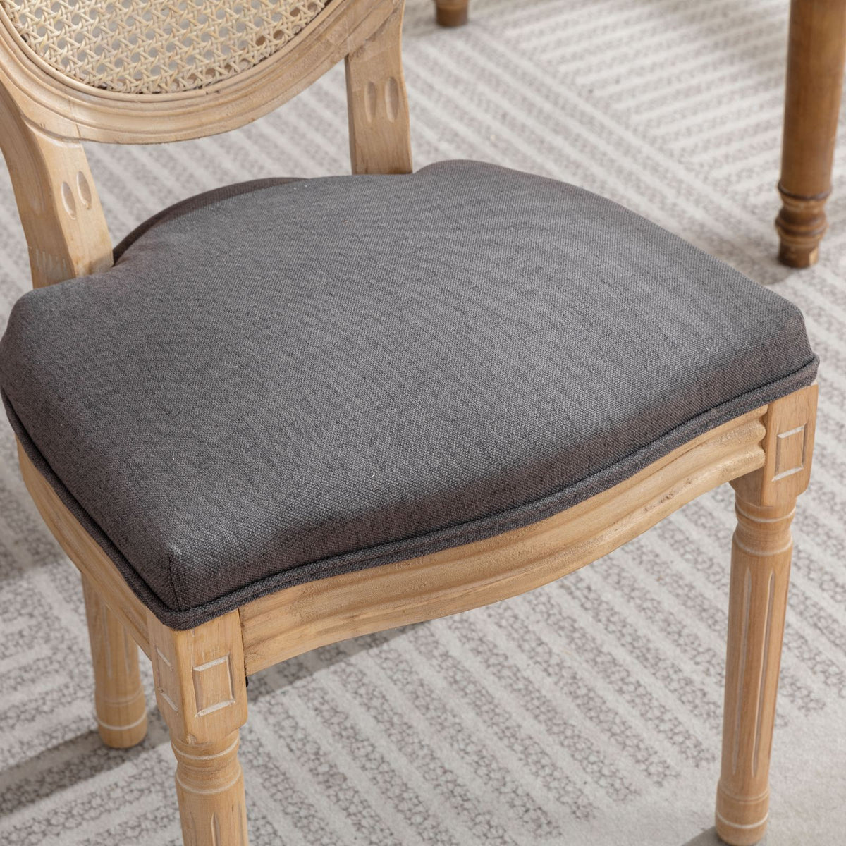 Celeste gray dining chair close-up of the woven cane medallion backrest