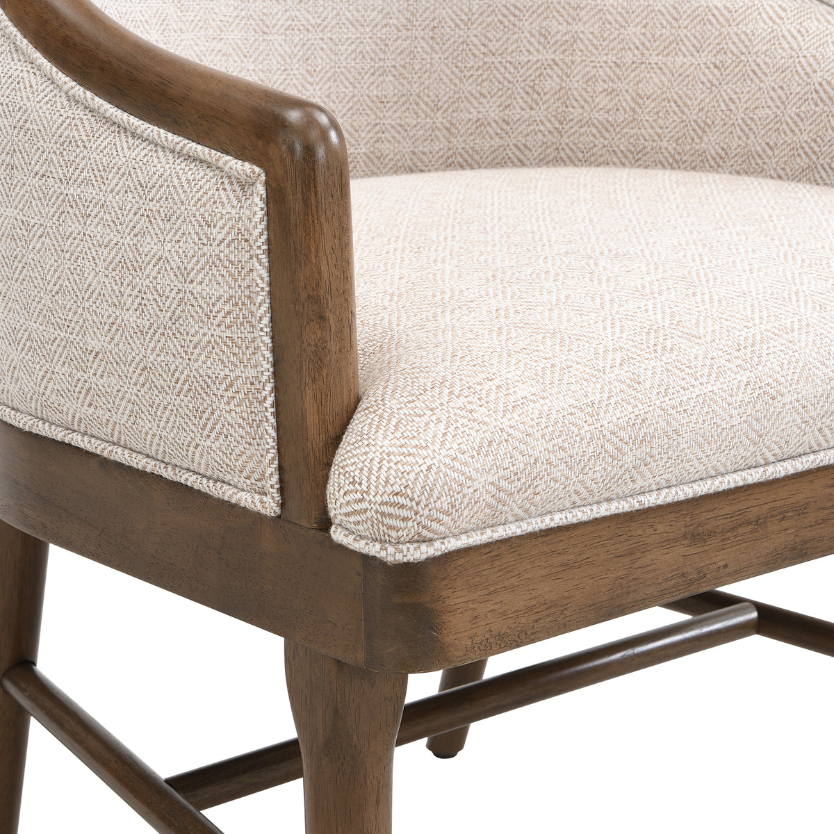 Chelan beige dining armchair close-up of the upholstered side panel and curved rubberwood frame