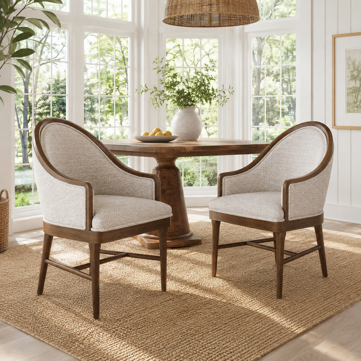 Chelan beige dining armchairs in a bright dining room with a dark round pedestal table