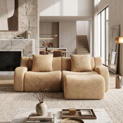 Chico camel loveseat sofa with ottoman in modern living room with marble fireplace and neutral decor