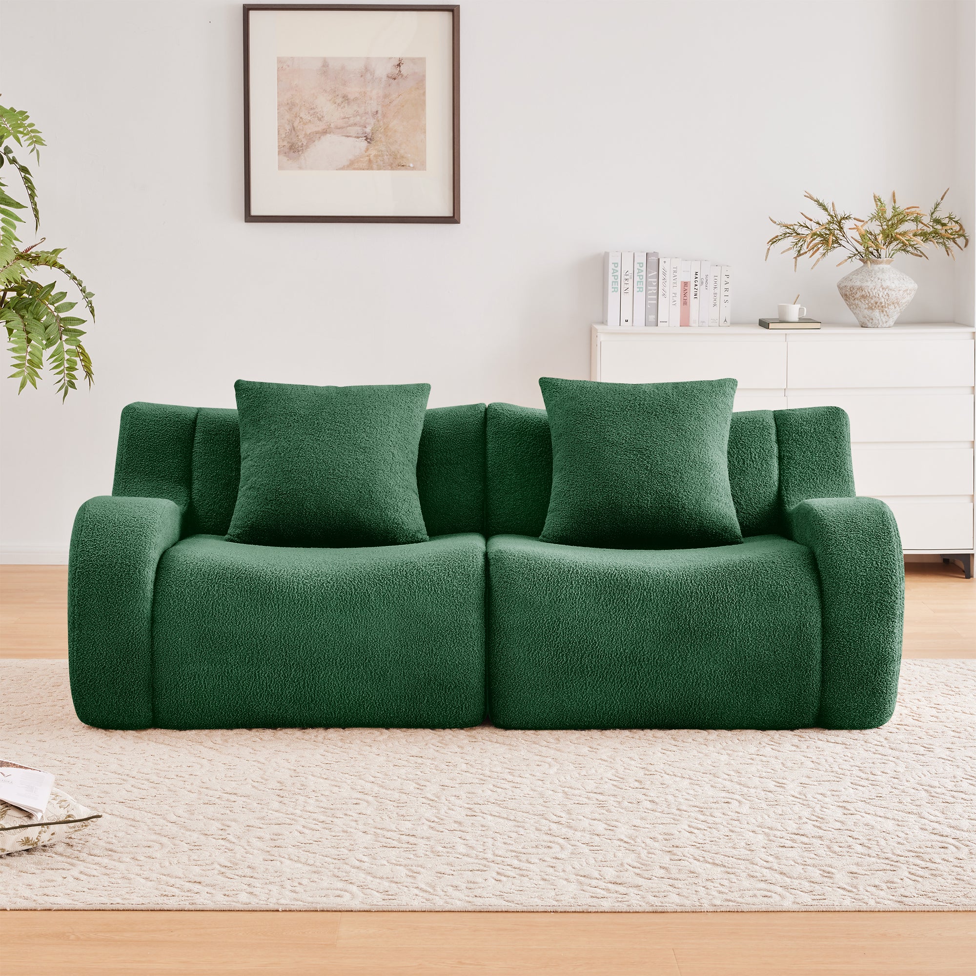 Chico green loveseat sofa showing front view with pillows in a bright living room