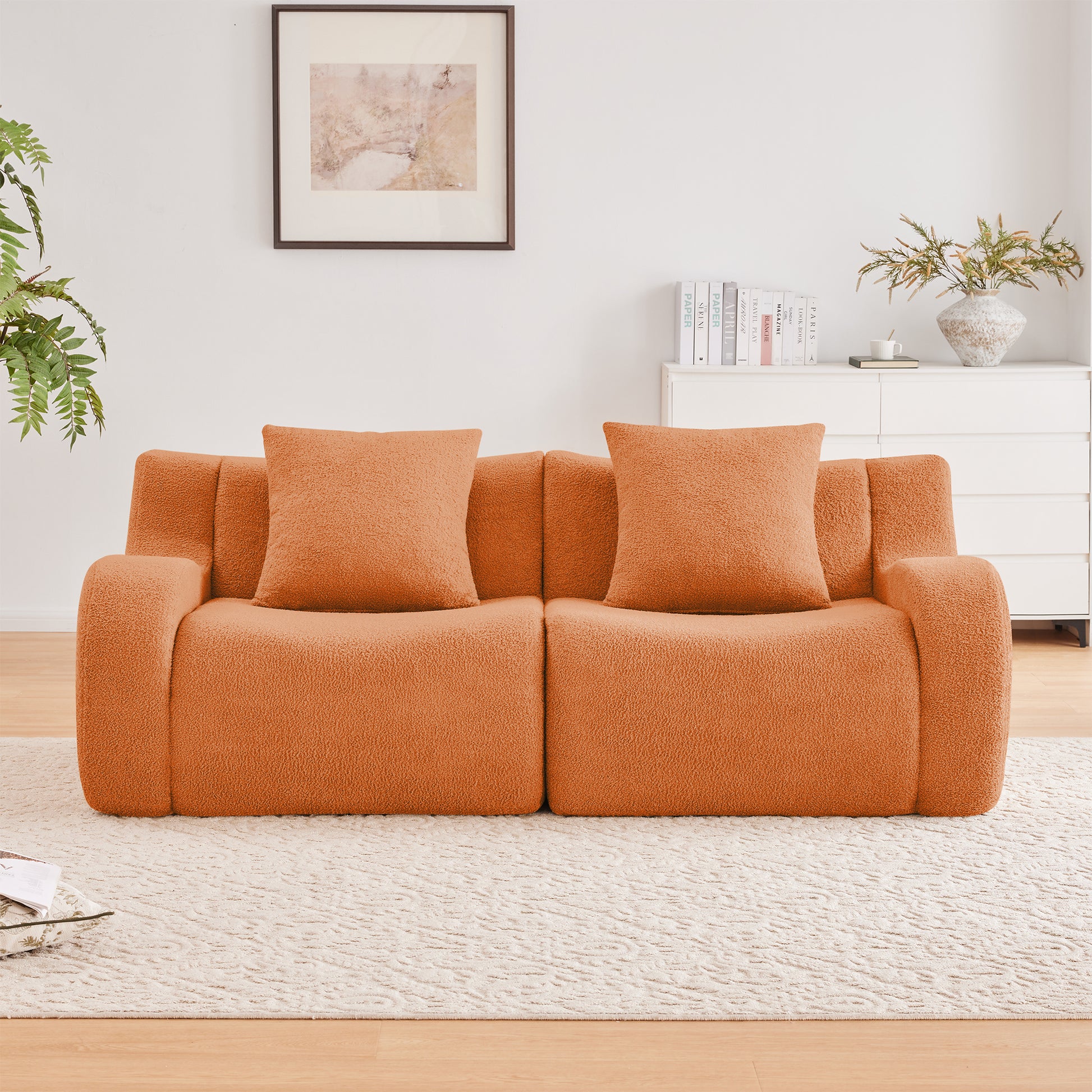 Chico orange loveseat sofa showing front view in a bright living room
