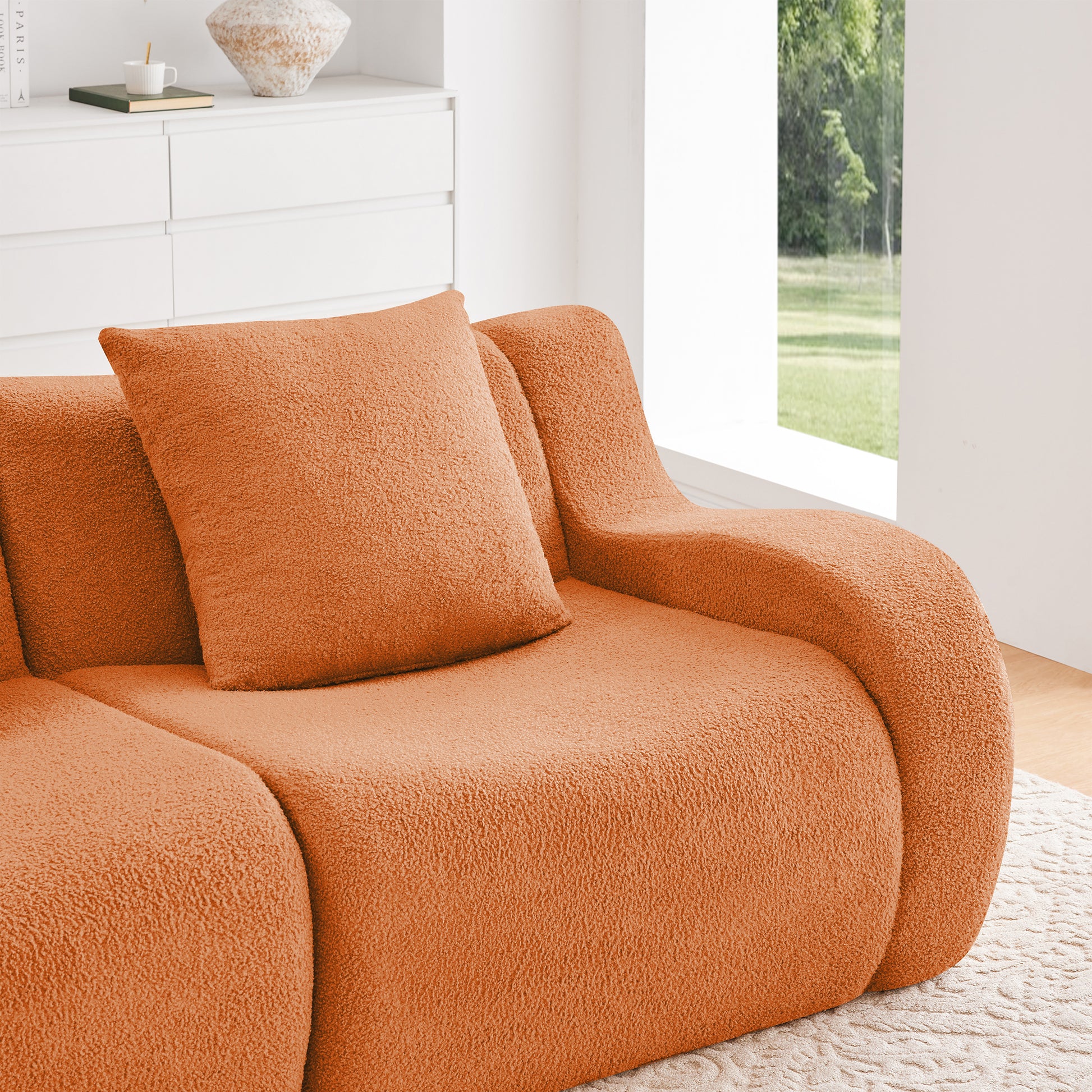 Chico orange teddy fabric sectional sofa seat cushion and curved armrest detail