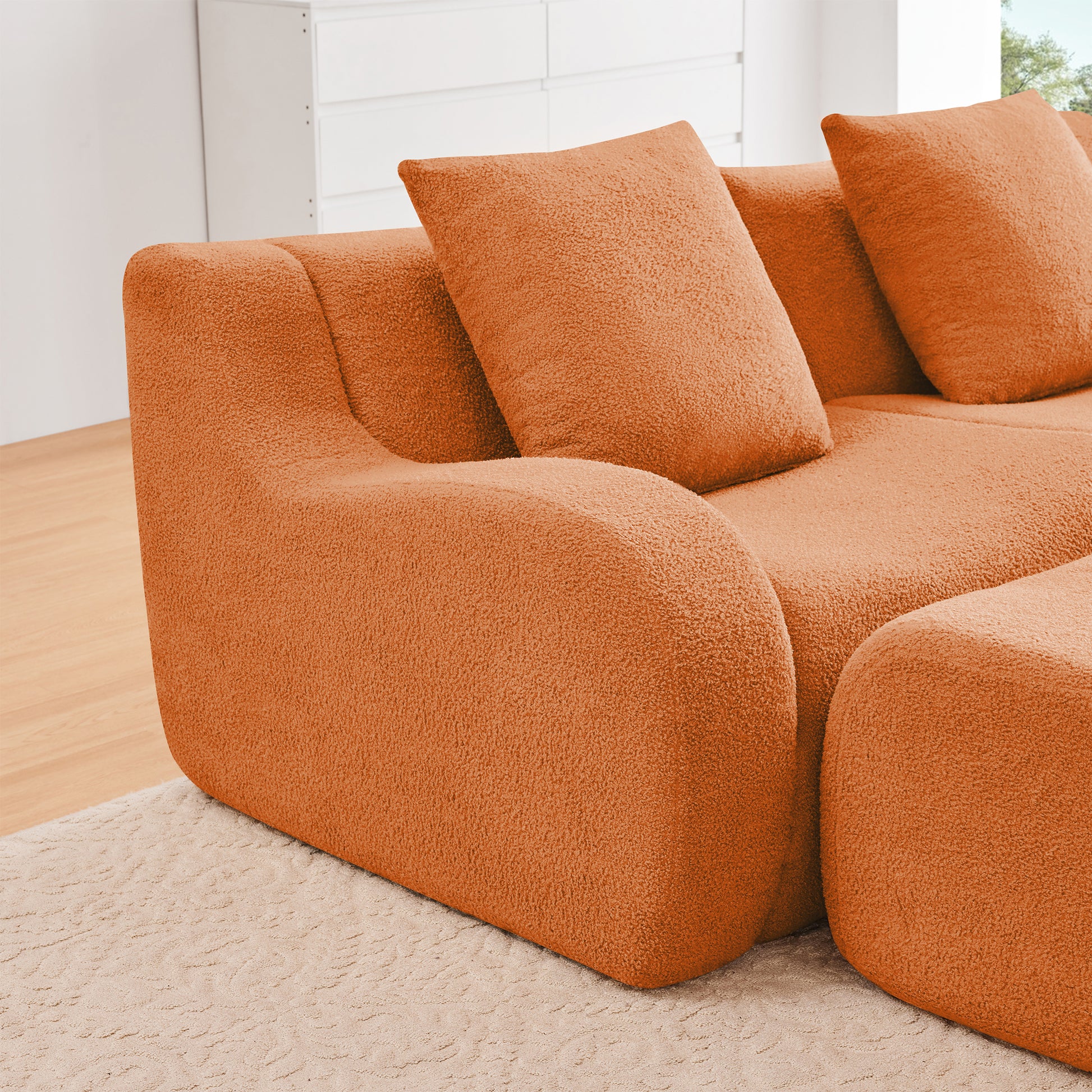 Chico orange teddy fabric sectional sofa curved armrest close-up detail