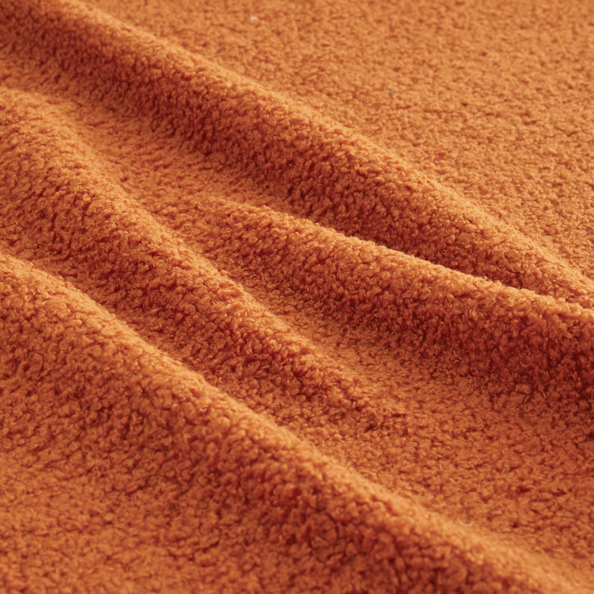 Close-up of Chico orange teddy fabric texture upholstery detail