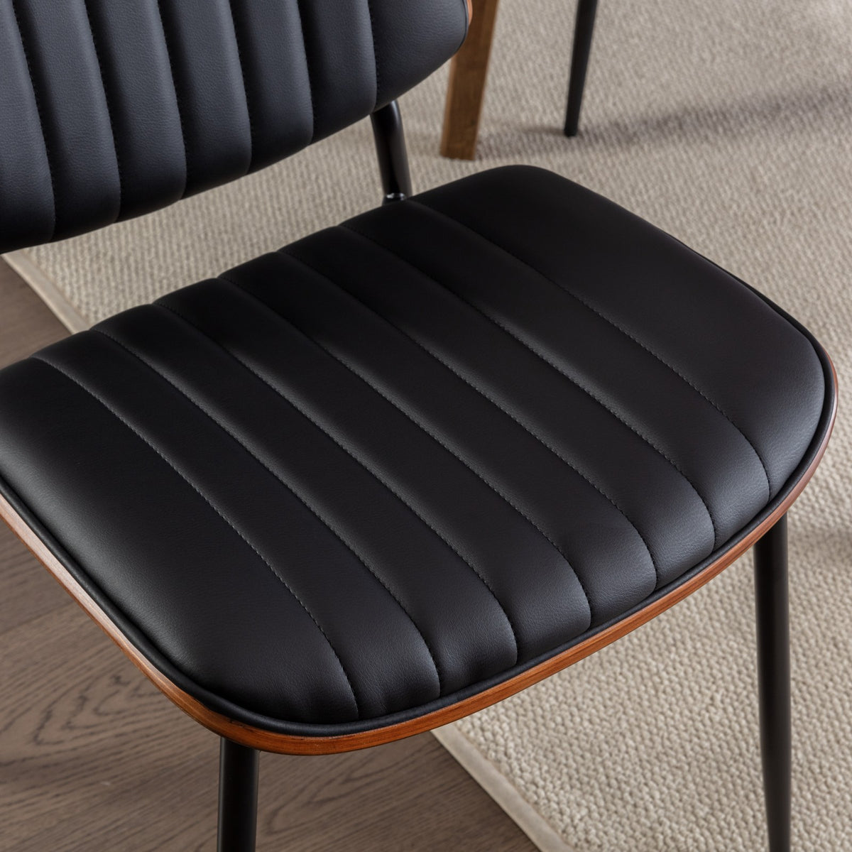 Colorado black dining chair close-up of the ribbed PU leather seat cushion with black upholstery