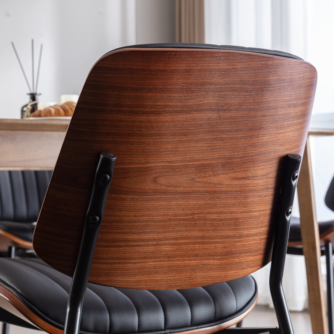 Colorado brown dining chair close-up of the curved wood back panel with warm walnut-tone finish