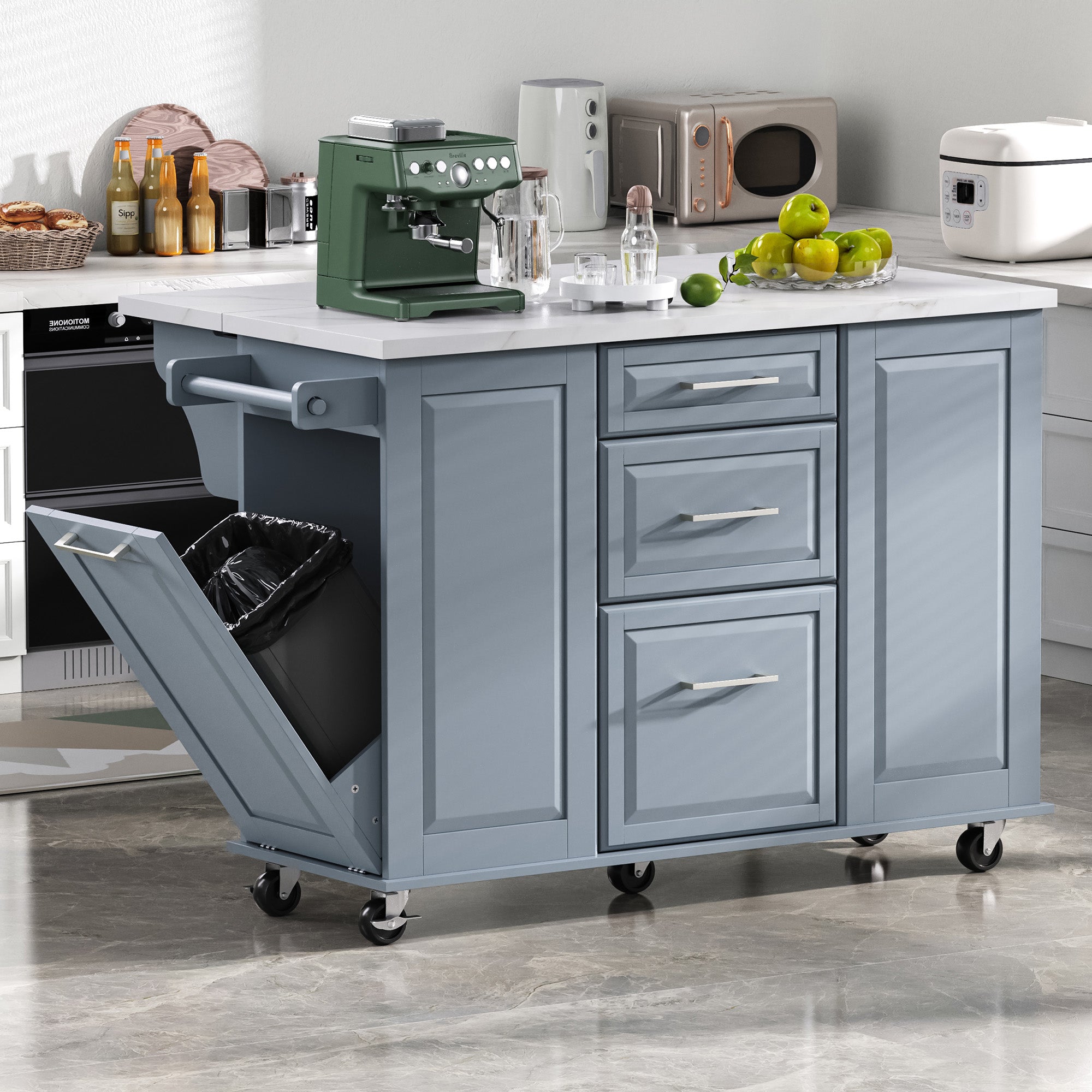 Deauville gray kitchen island showing drop leaf countertop hidden tilt-out trash cabinet drawers and rolling storage in a modern kitchen