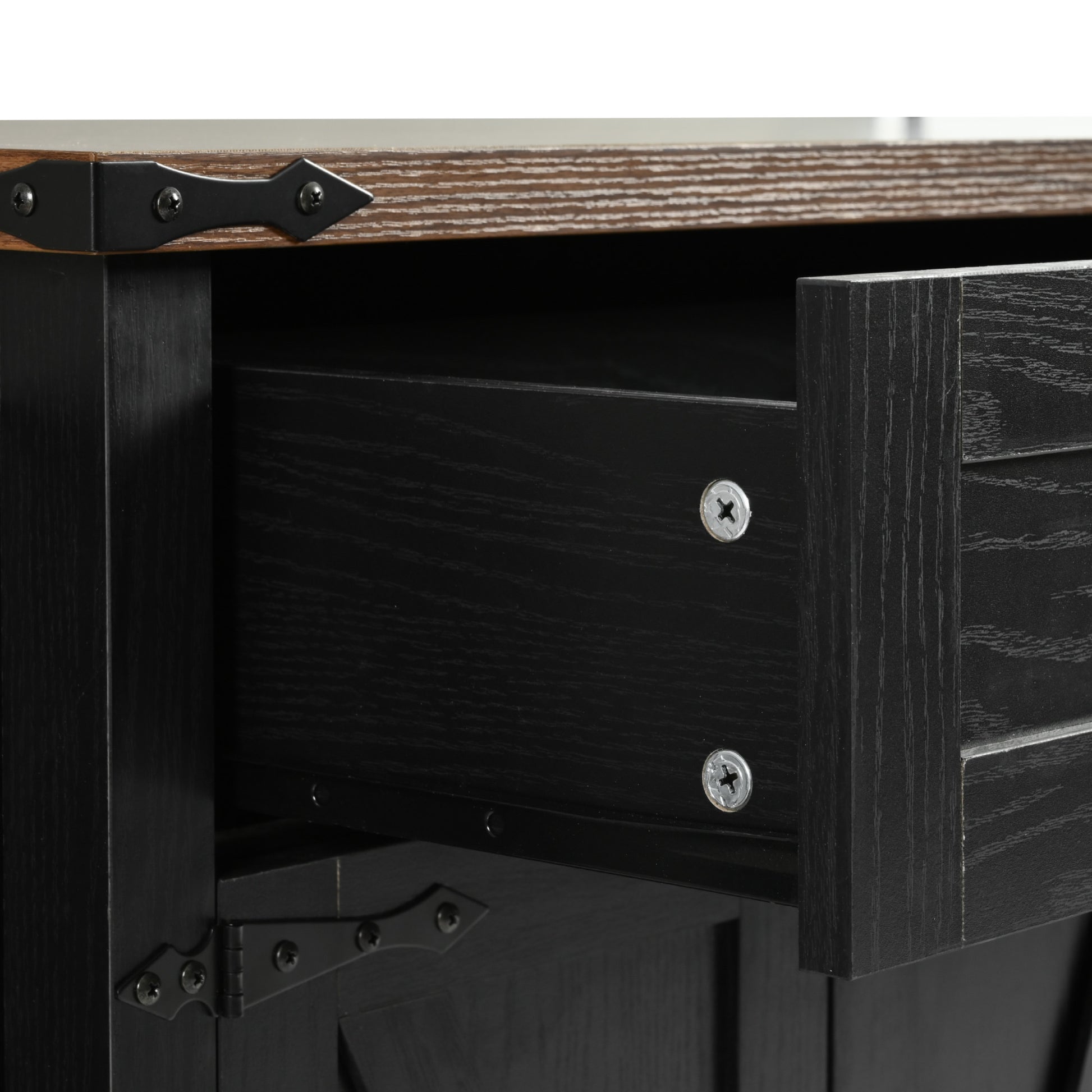 Close-up detail of black Dijon farmhouse kitchen island drawer wood grain texture and metal hardware with rustic countertop edge isolated on white background