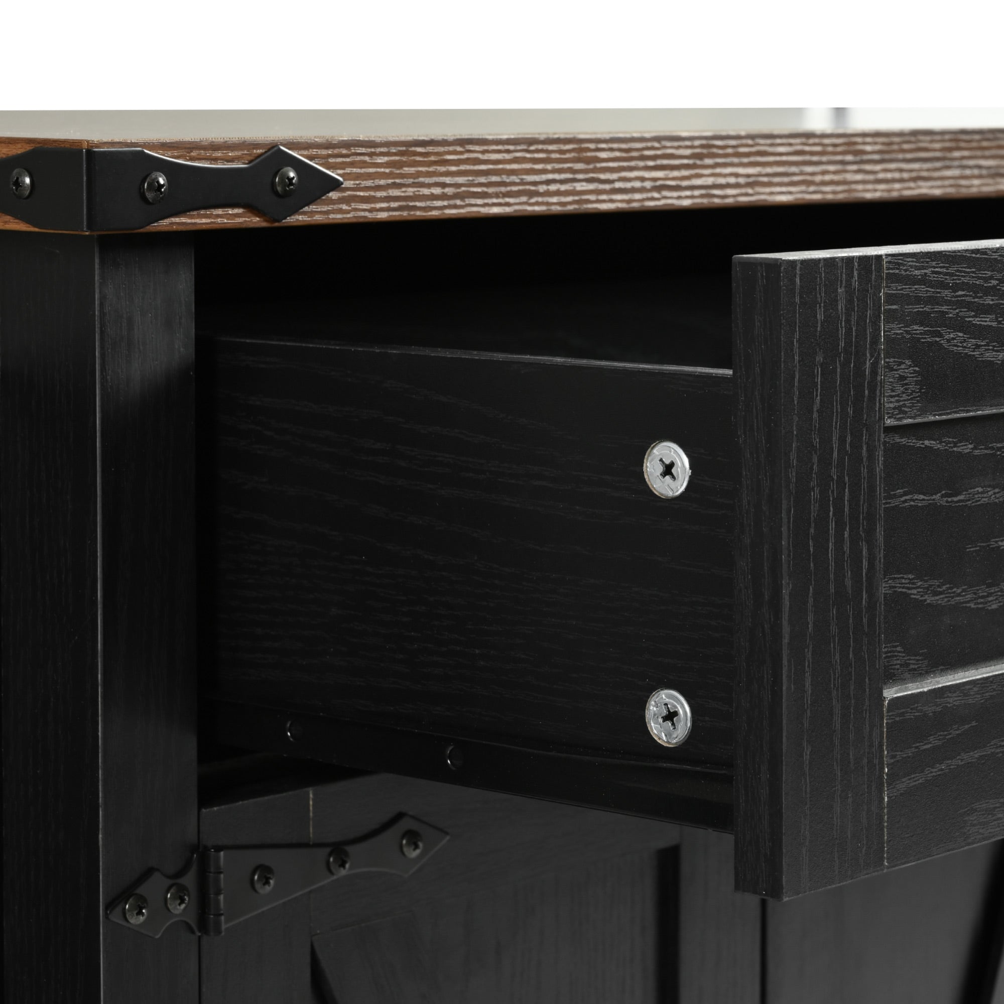 Close-up detail of black Dijon farmhouse kitchen island drawer wood grain texture and metal hardware with rustic countertop edge isolated on white background