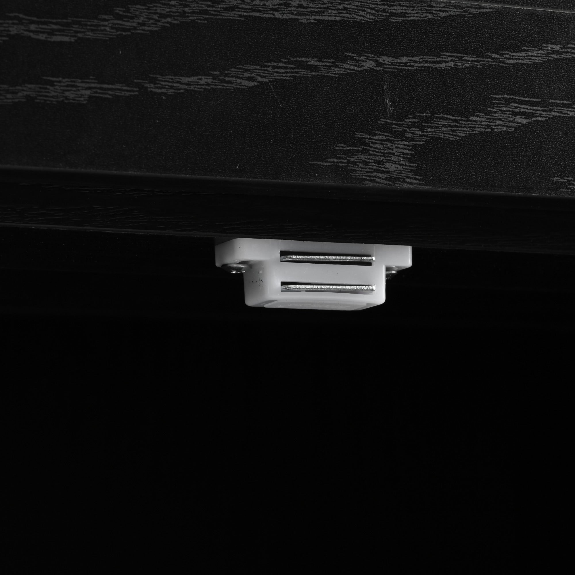 Close-up detail of built-in USB charging port on black Dijon farmhouse rolling kitchen island isolated on white background