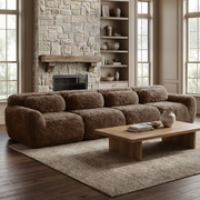The 149-inch Durham Brown Modular Plush Sofa, situated in a cozy living room with fireplace