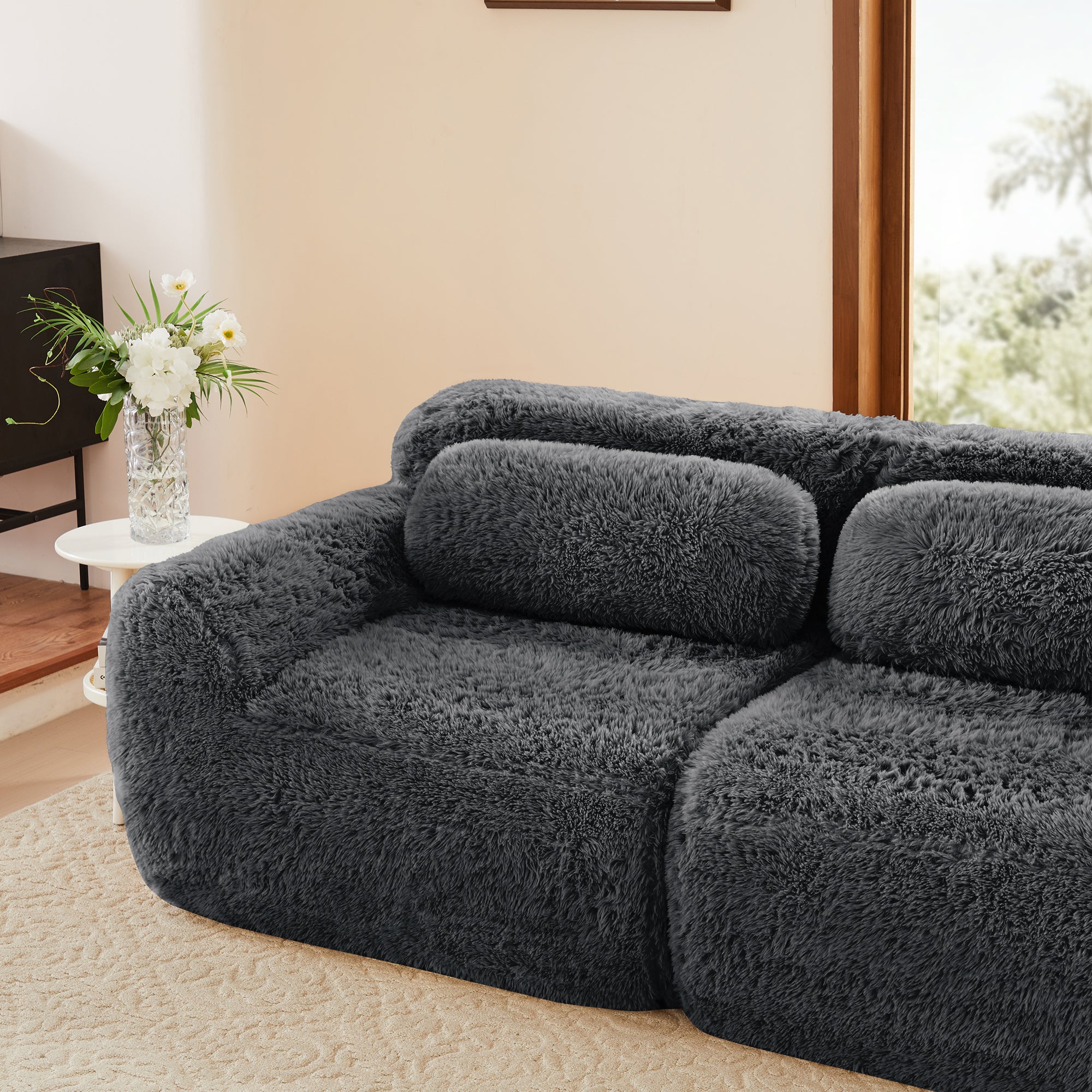Durham grey sectional sofa showing rounded armrest and fluffy fabric texture detail