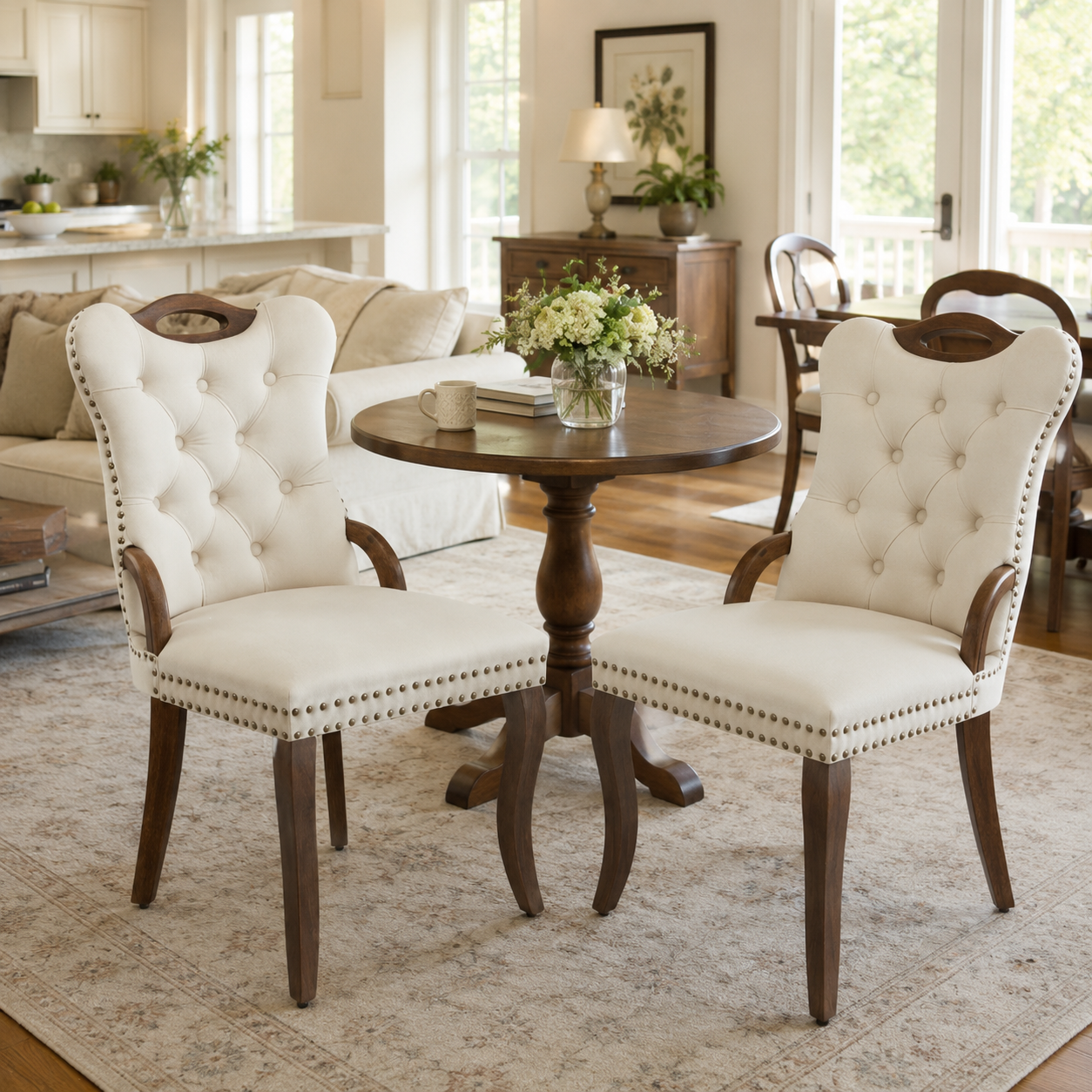 Elbe beige dining chairs showing a pair around a round pedestal table in a bright dining room