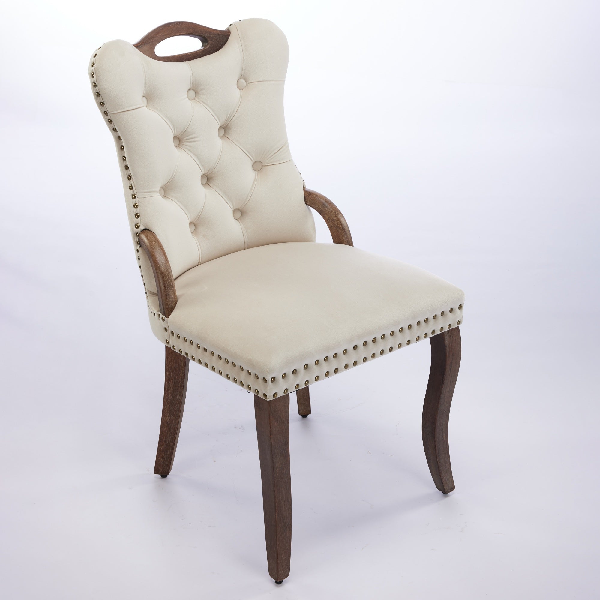 Elbe beige dining chair showing an angled front view with wood armrests and nailhead trim