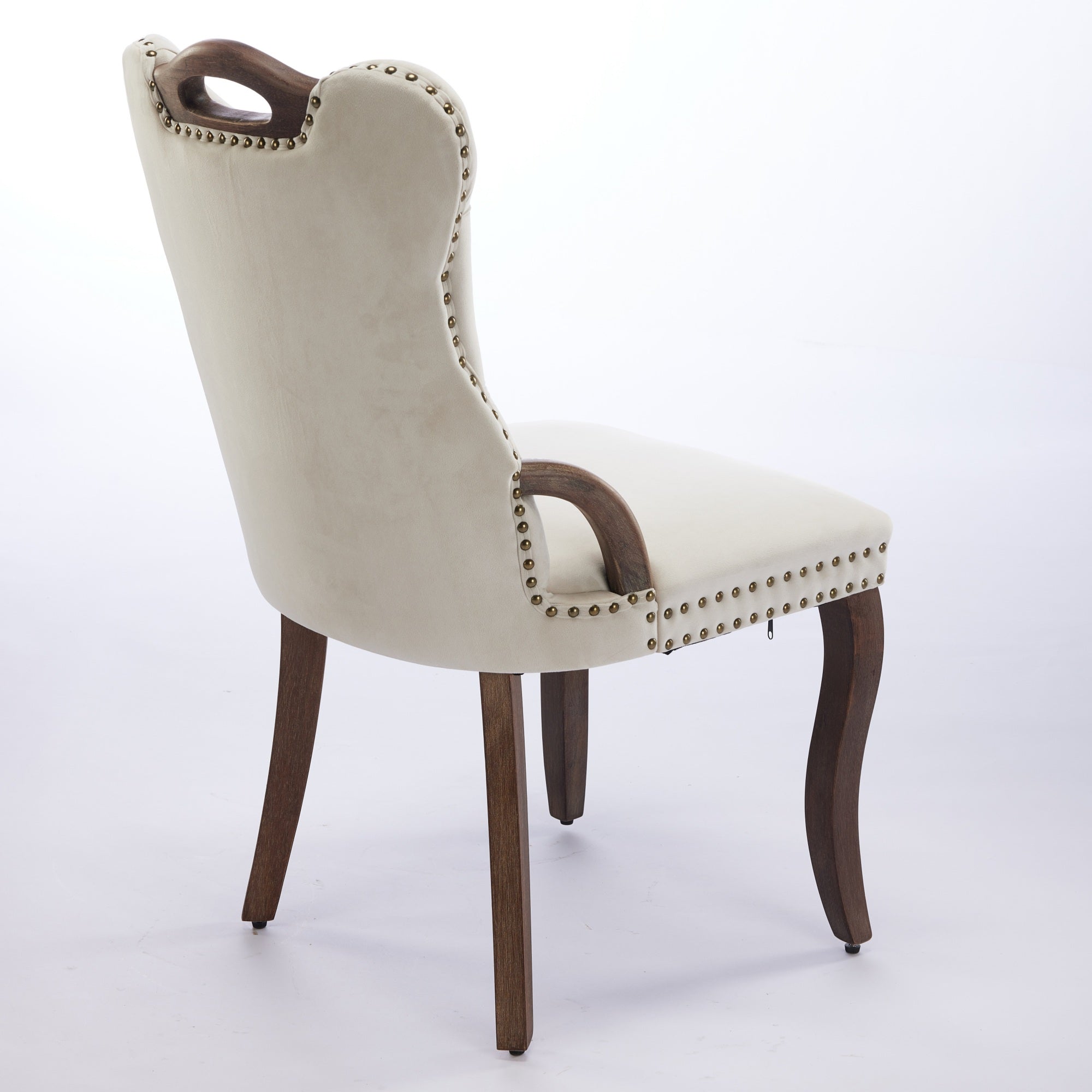 Elbe beige dining chair showing a rear angled view with upholstered back and wood handle
