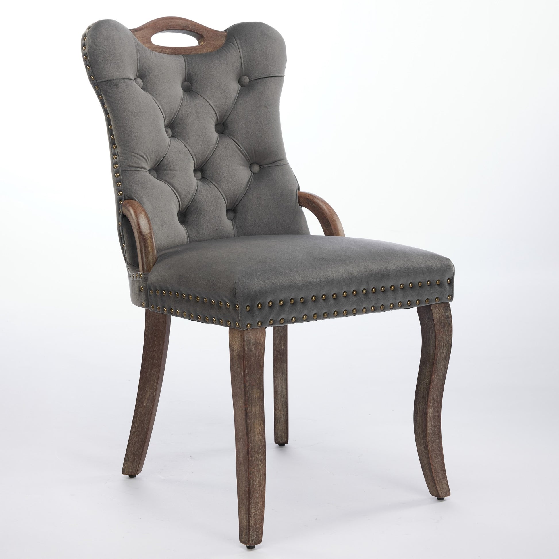Elbe gray dining chair showing an angled front view with wood armrests and nailhead trim